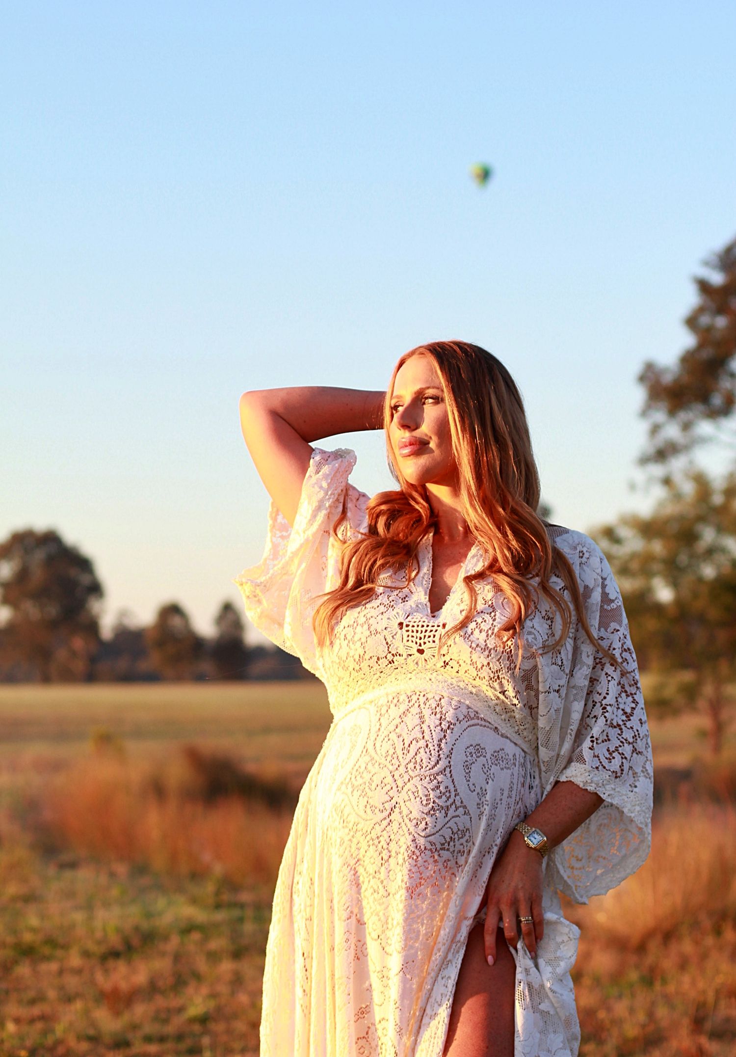 Sunrise maternity session capturing an expectant mother in soft morning light.