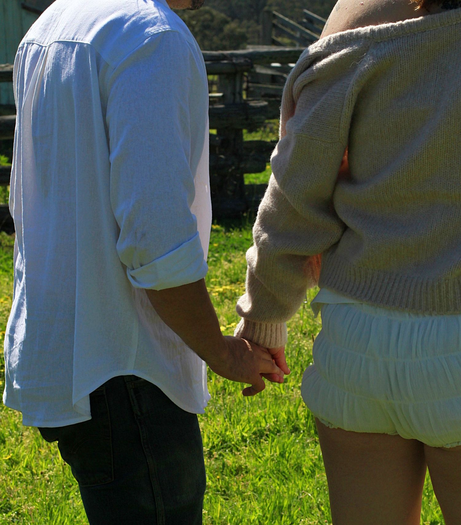 Behind shot of couple holding hands during an engagement session