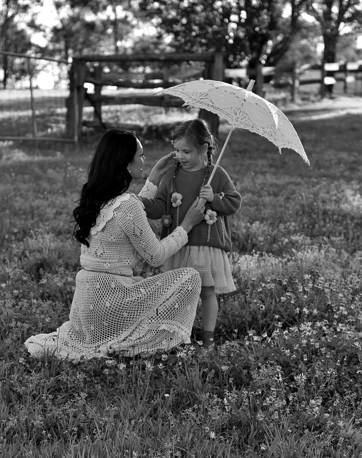 Mum and daughter sharing a quiet moment in nature during a family session