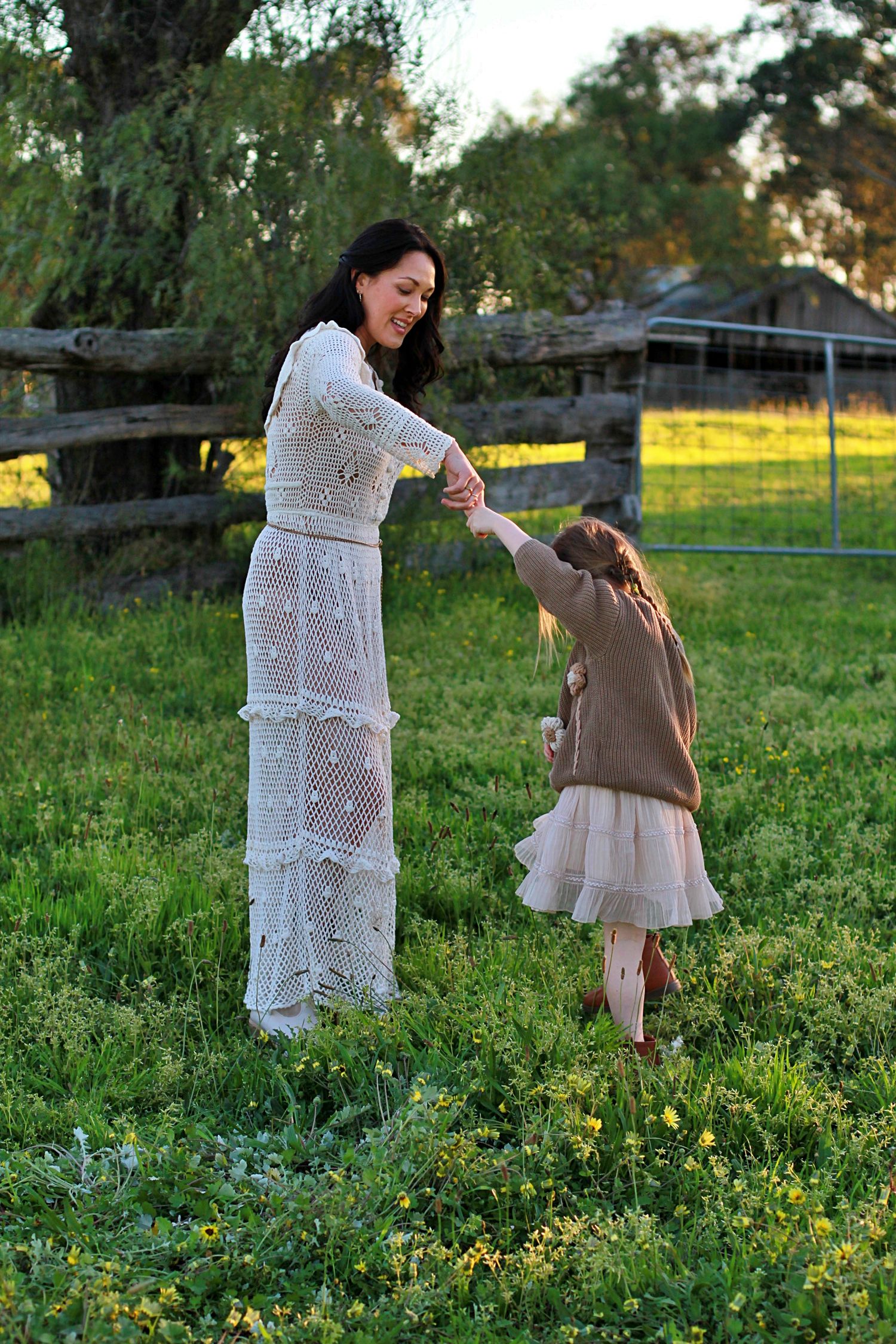 Daughter and mum dancing in the field during a family session