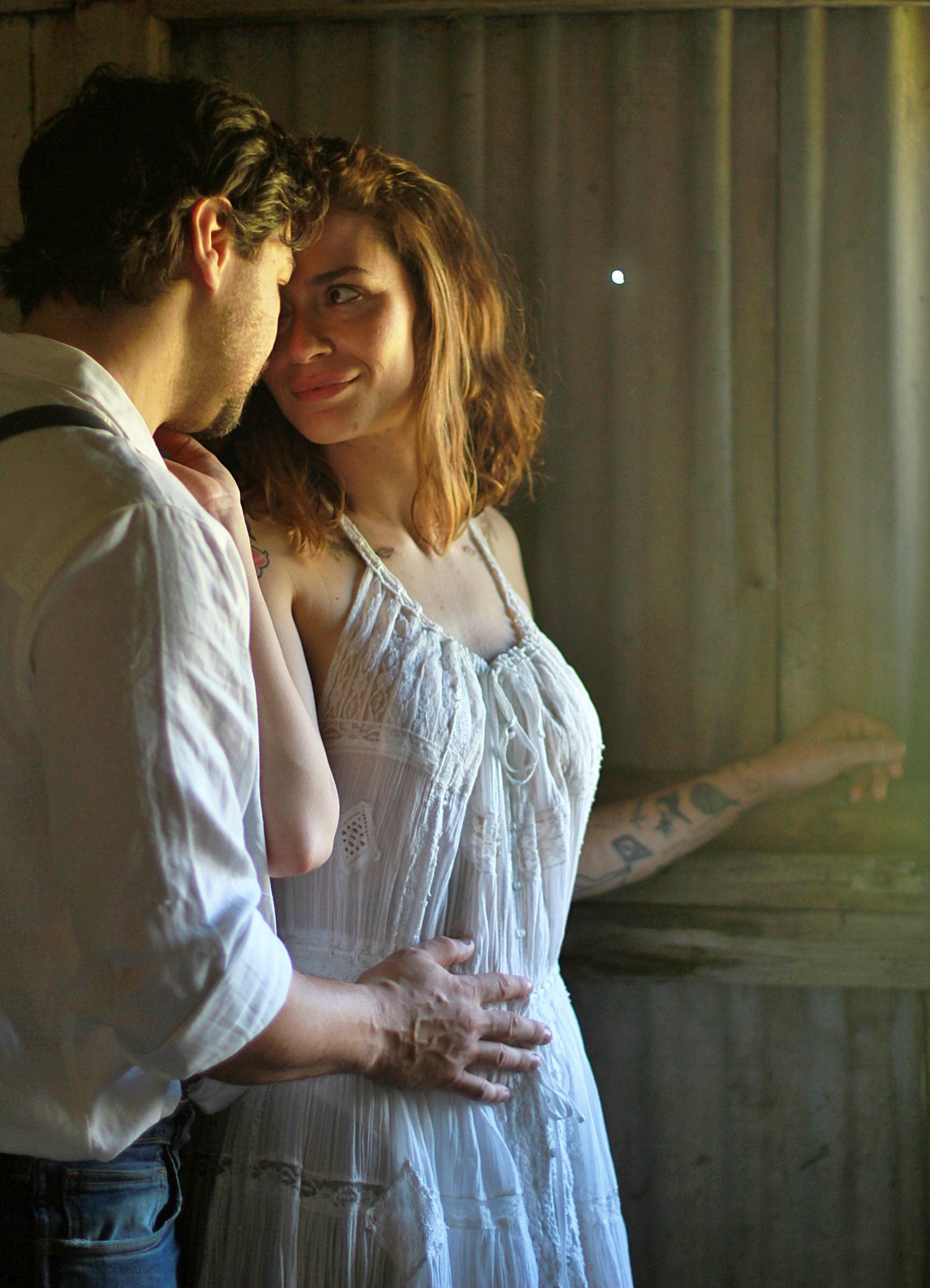 Intimate engagement portrait with foreheads touching and soft eye contact