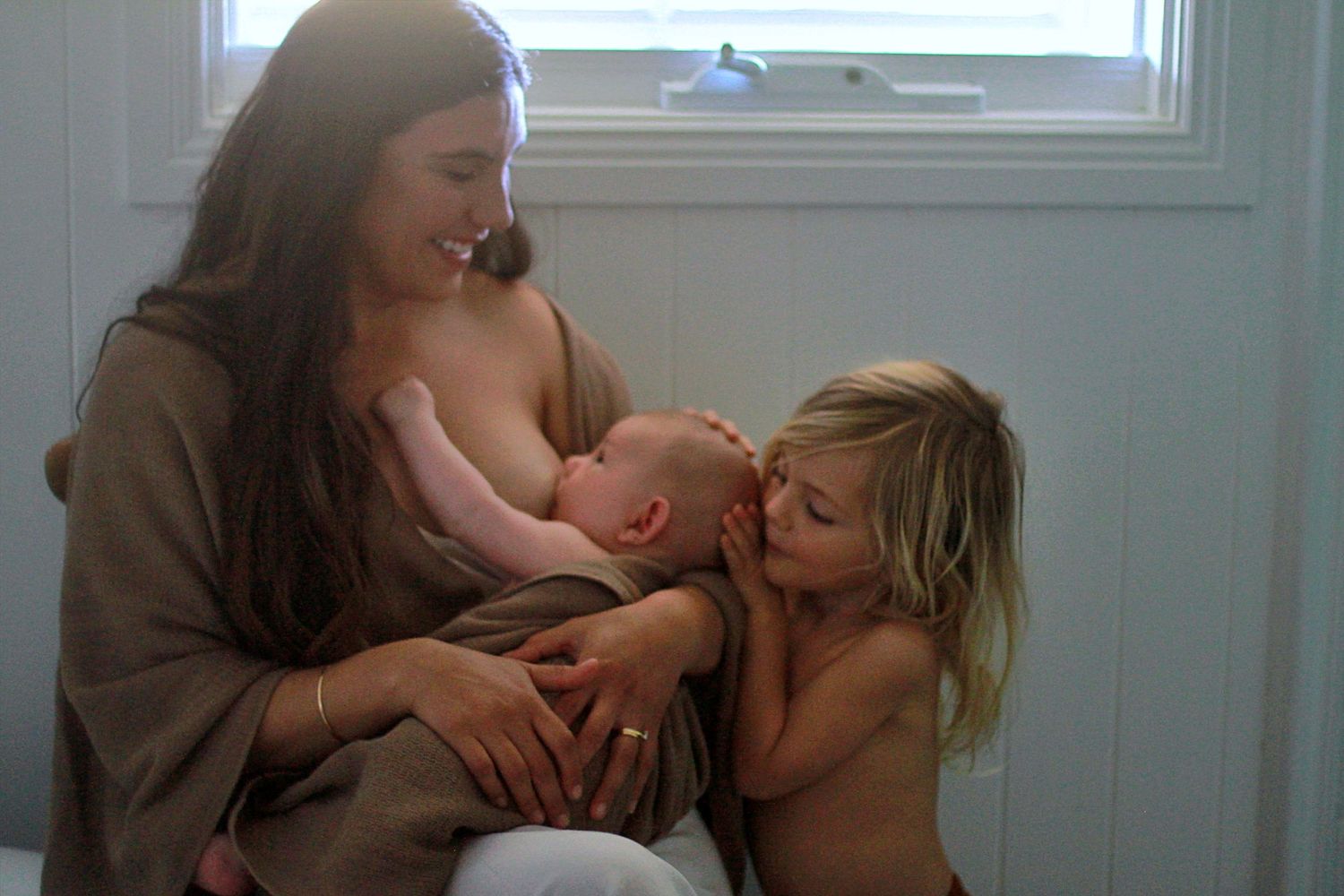 Candid moment of sibling love in a lifestyle motherhood photoshoot by A Lasting Impression Photography.