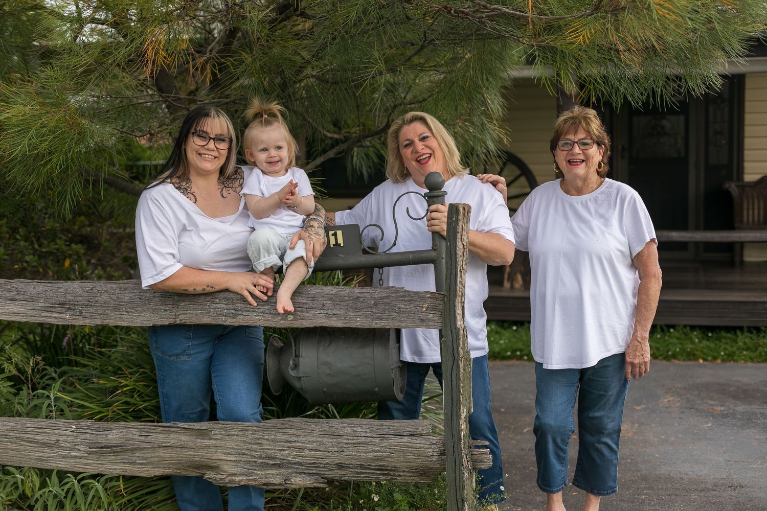 Four generations of women together; grandma, her daughter, granddaughter and great-granddaughter during an outdoor family photography ses
