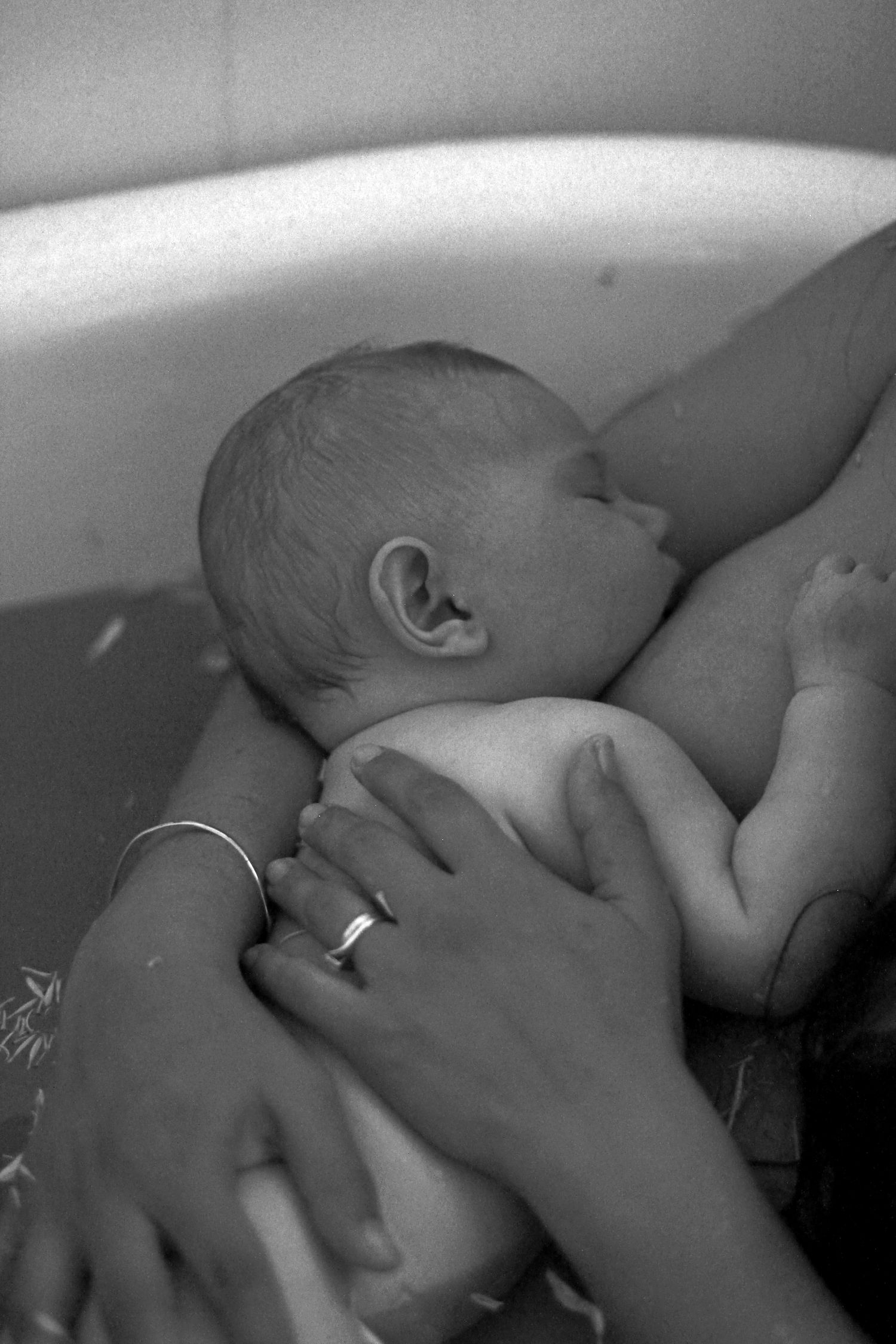 Mother breastfeeding her baby during a natural lifestyle motherhood session at home by A Lasting Impression Photography.