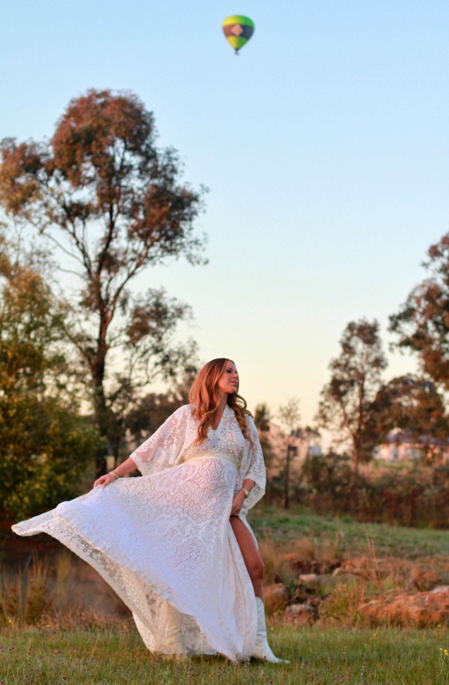 Mumma-to-be spinning her dress at sunrise during a lifestyle maternity photoshoot