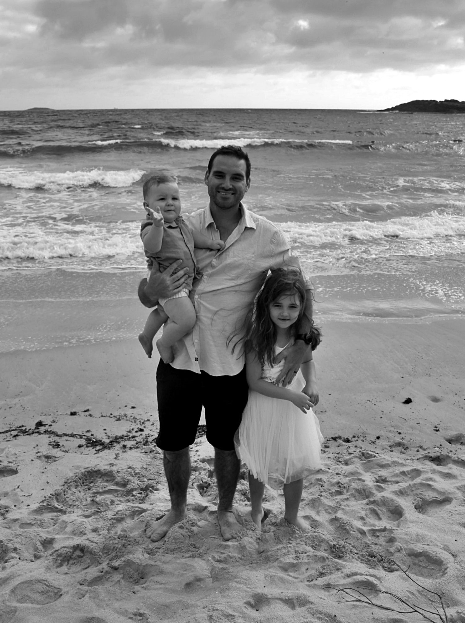 Natural beach portraits of dad with his daughter and son in the Illawarra.