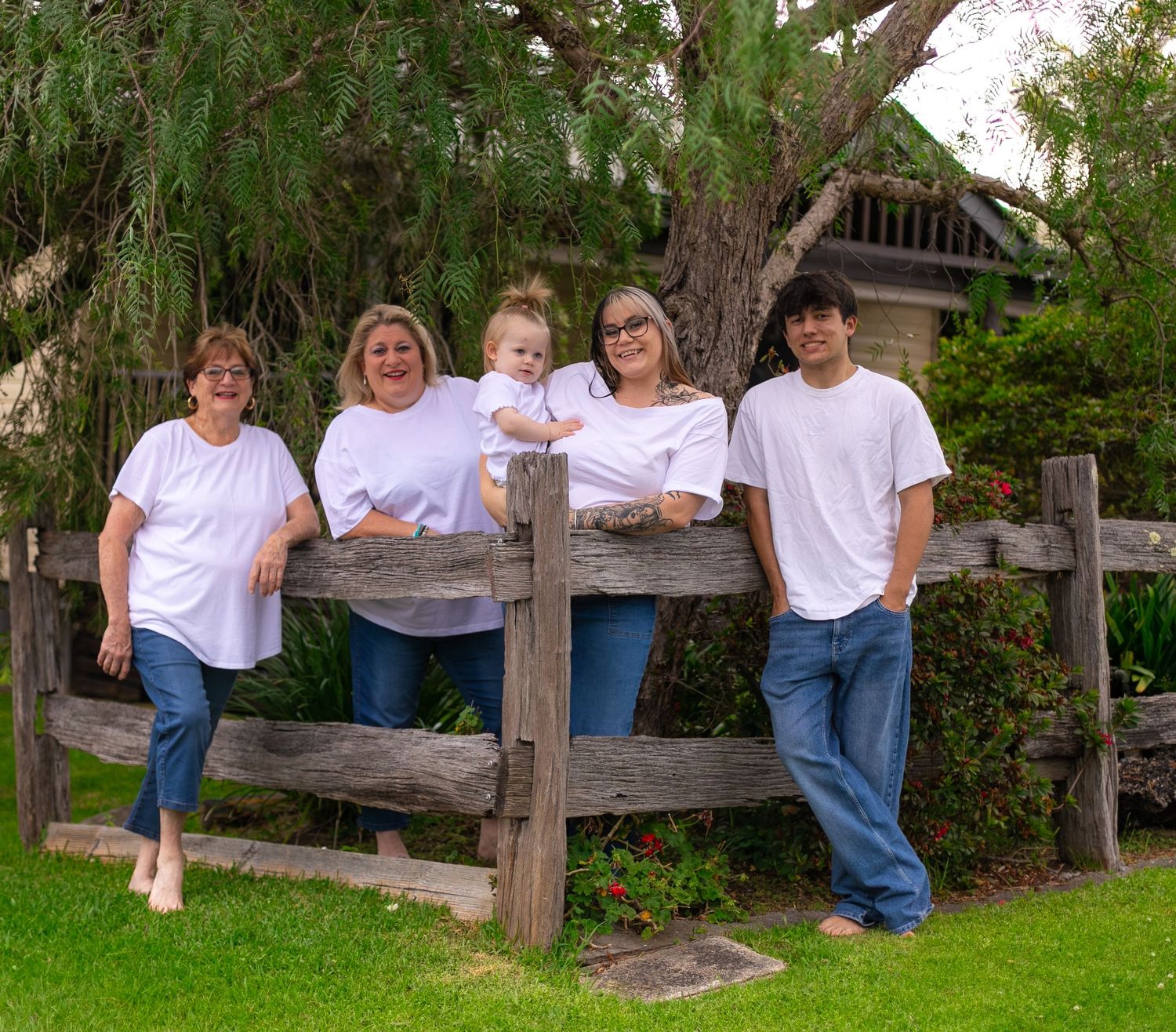 Grandma laughing with her daughter, granddaughter, grandson and great-granddaughter during an outdoor generational family photography sessio