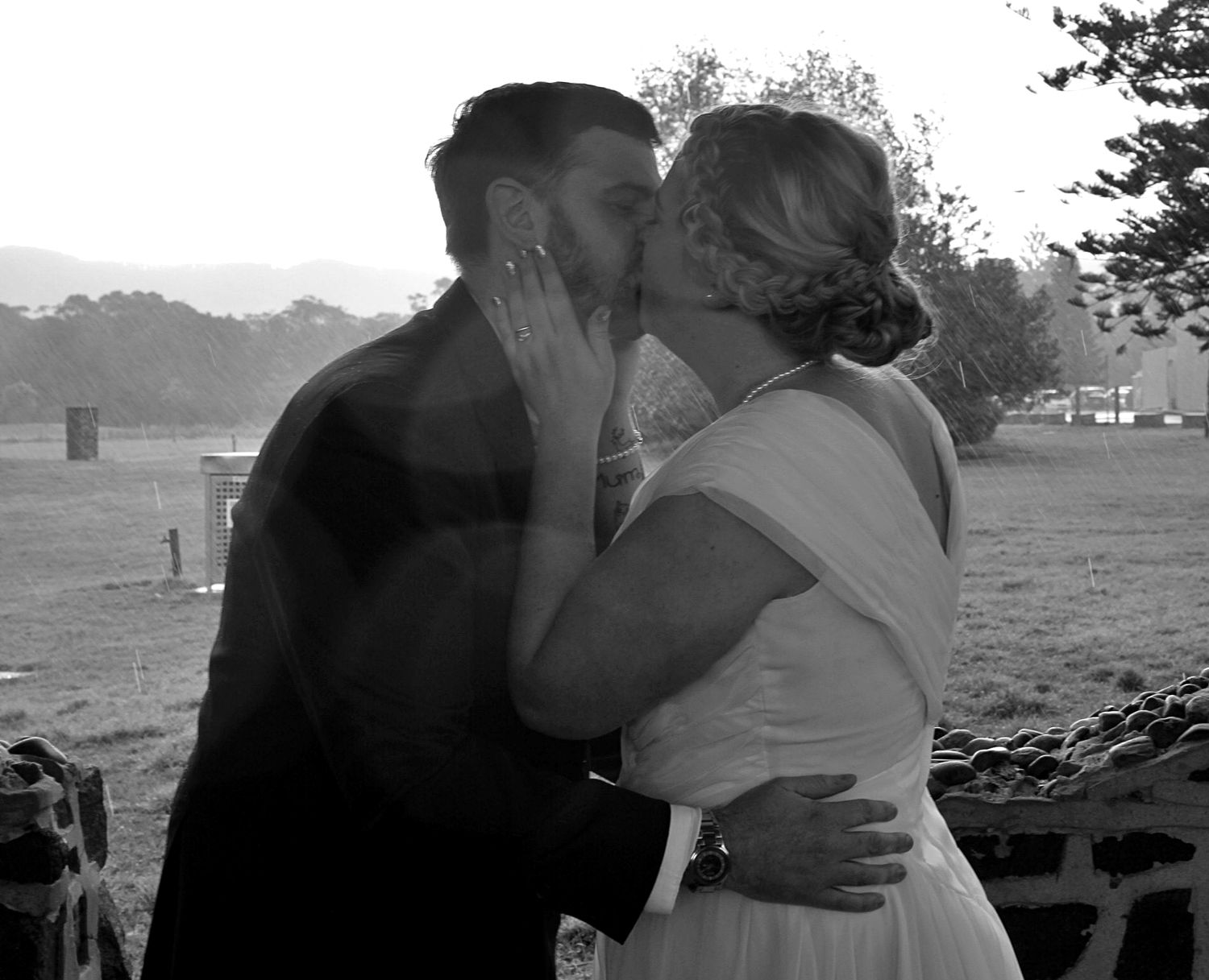 Bride and groom sharing their first kiss during a Wollongong wedding ceremony.