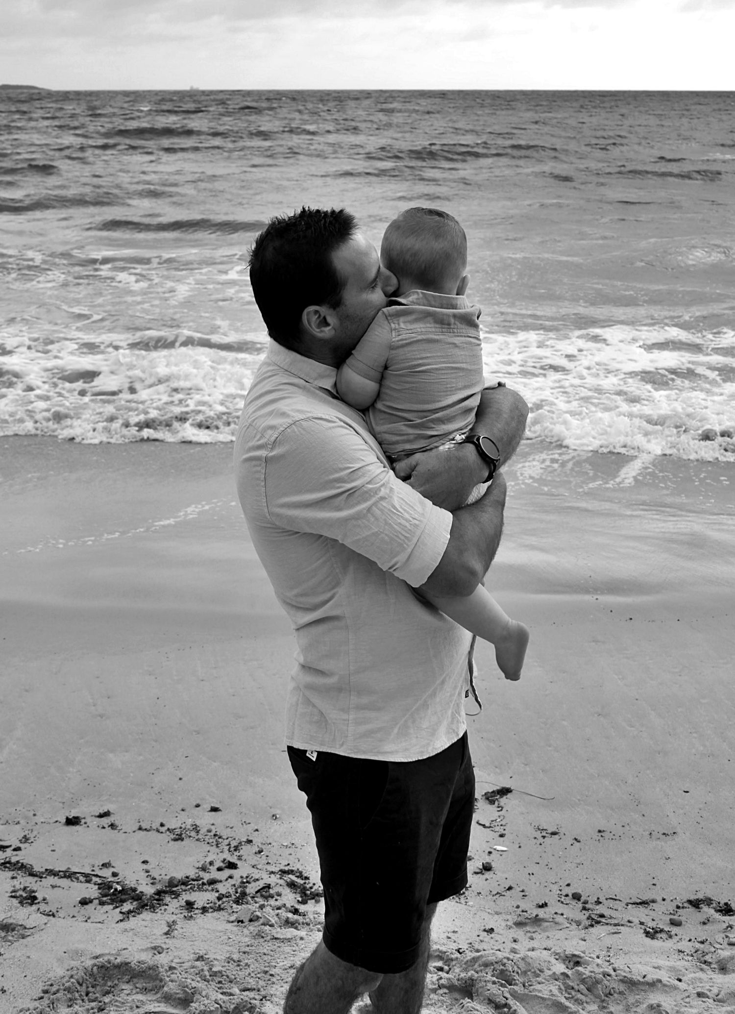 Dad and son portraits on the beach in the Illawarra, capturing loving connection and natural coastal moments.