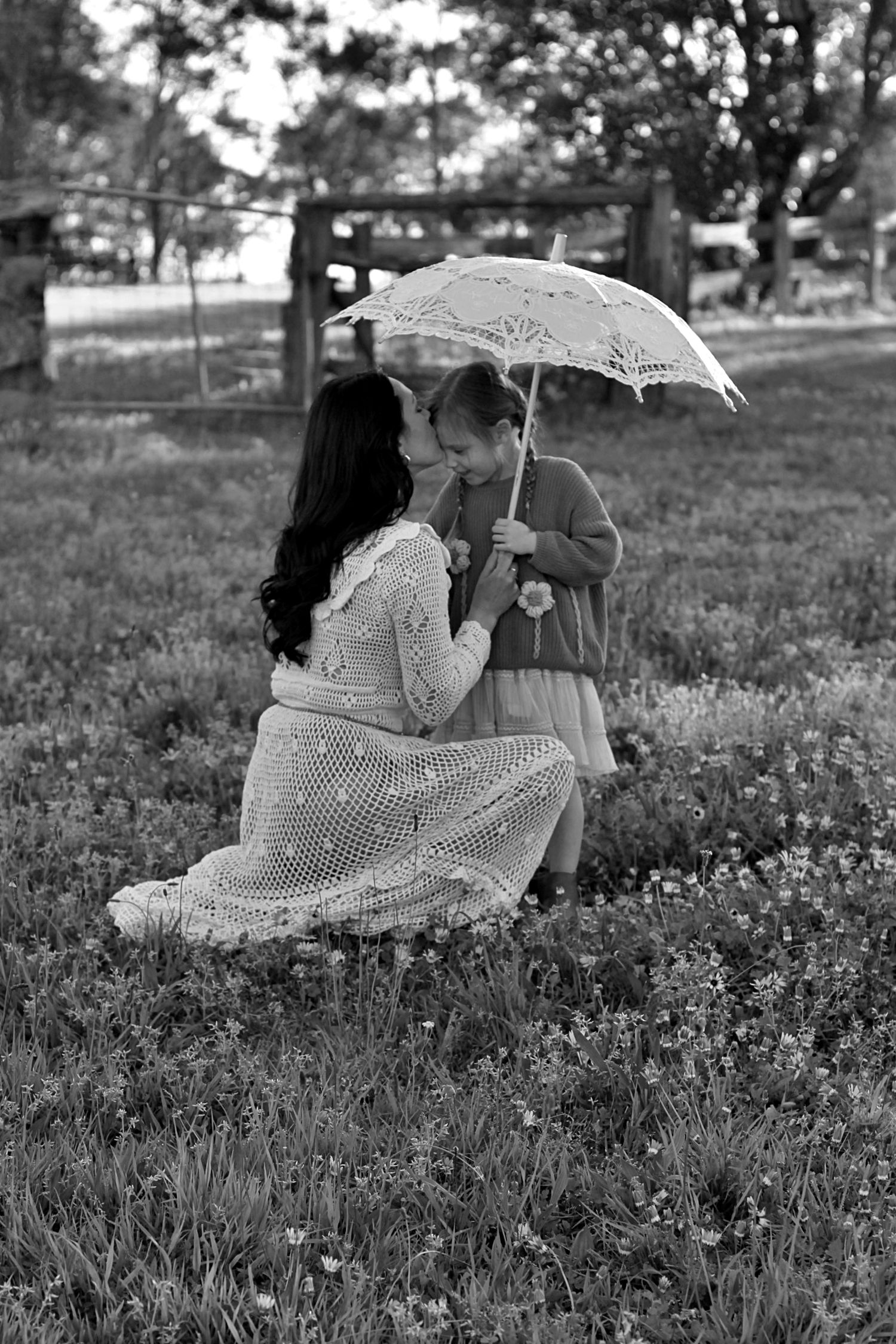 Mum and daughter sharing a quiet moment in nature during a family session