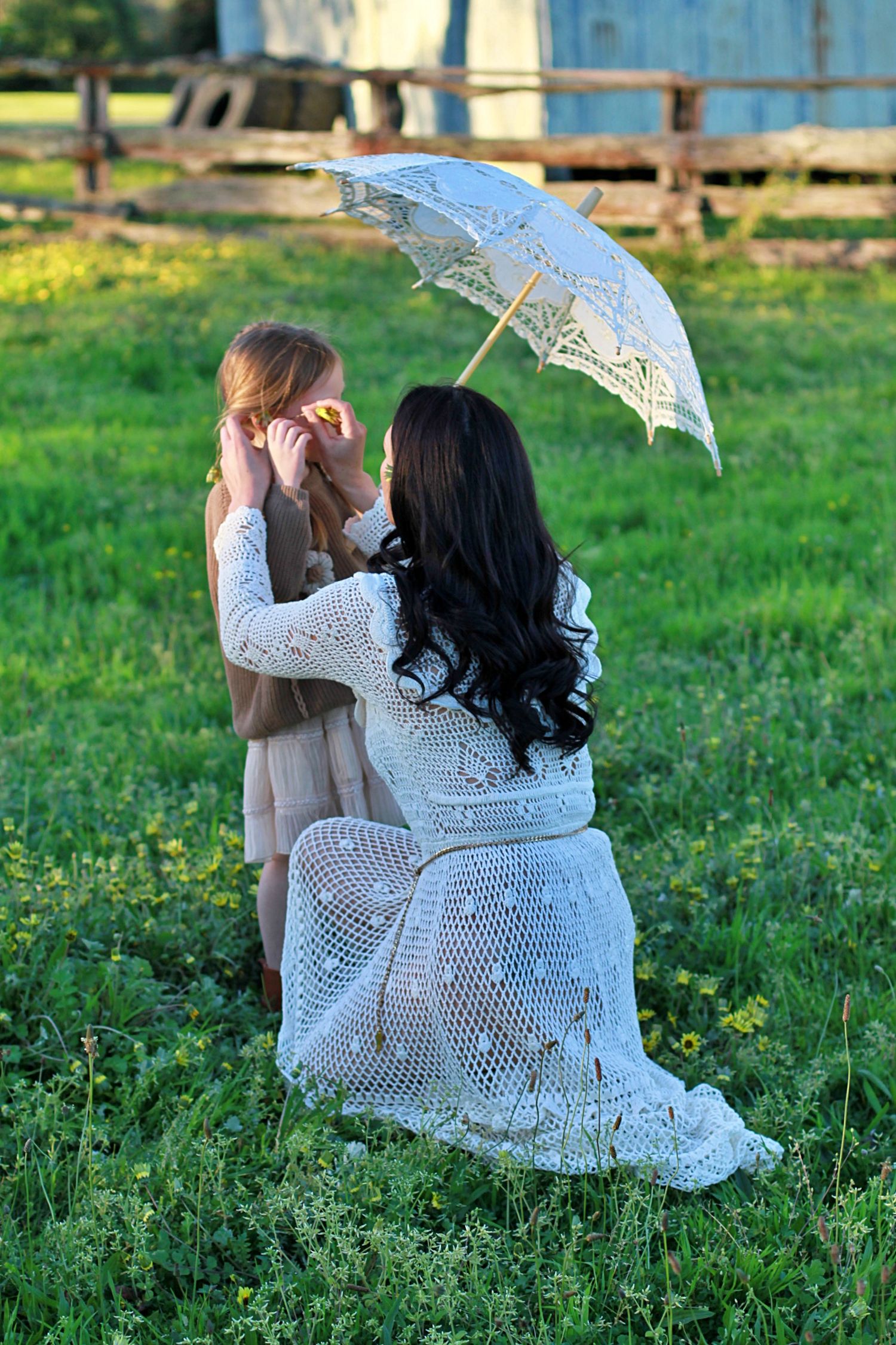 Mum and daughter sharing a quiet moment in nature during a family session