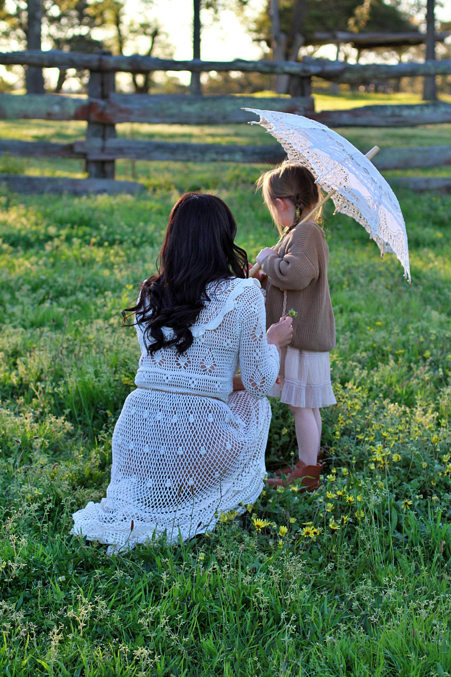 Mum and daughter sharing a quiet moment in nature during a family session