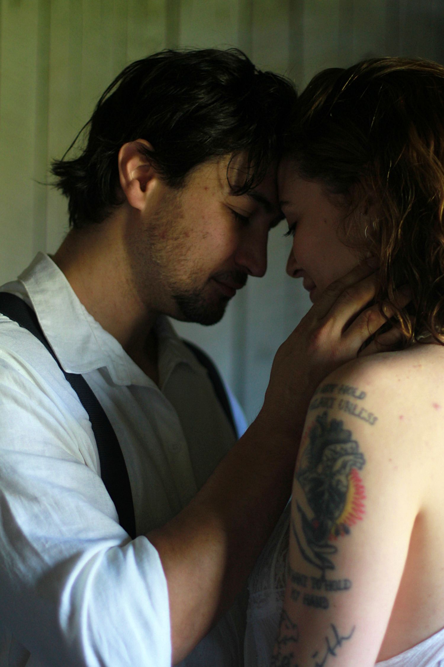 Romantic engagement photo of a couple touching foreheads and gazing into each other’s eyes