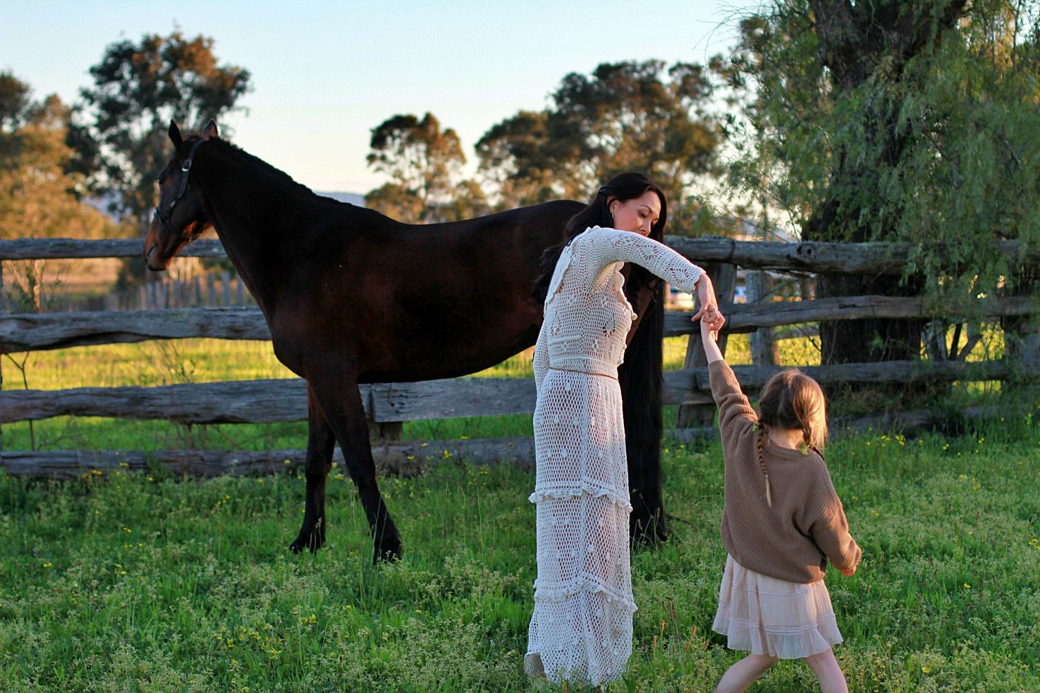 Daughter and mum dancing in the field during a family session