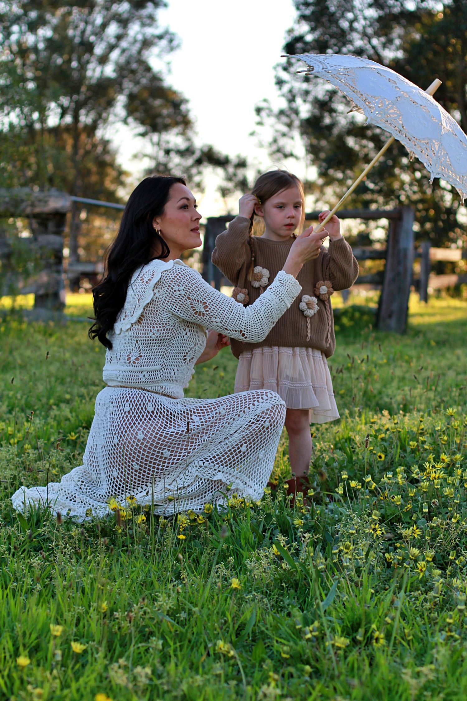 Mum and daughter sharing a quiet moment in nature during a family session