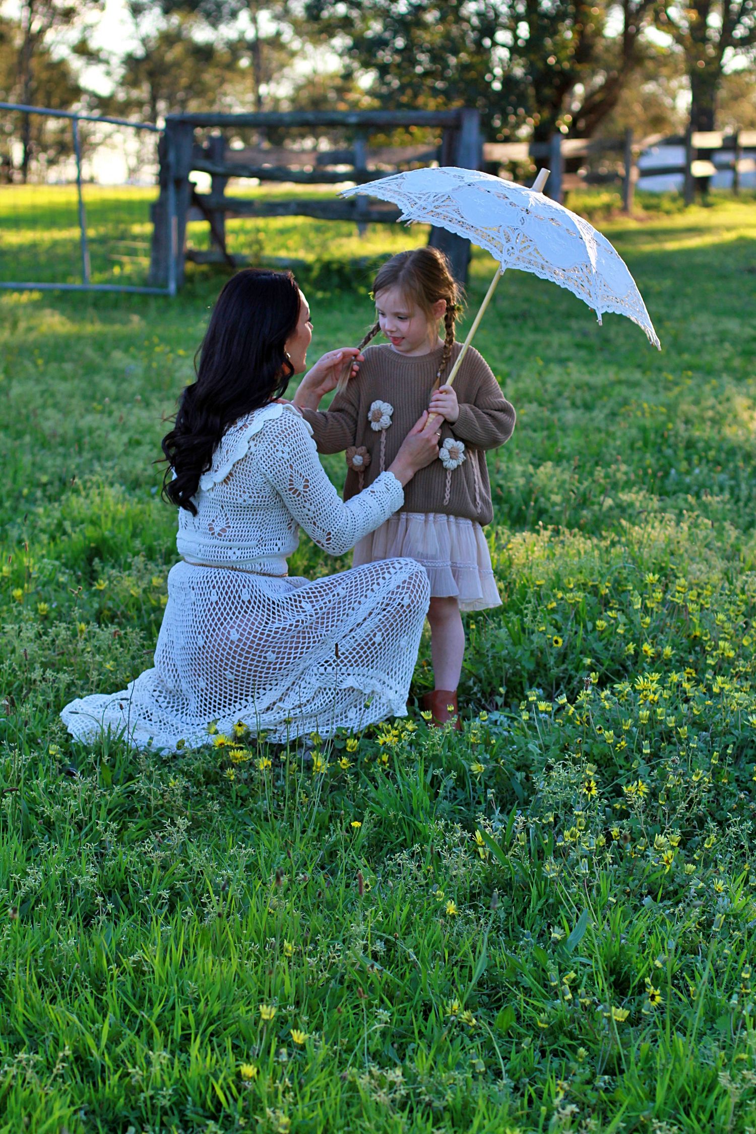 Mum and daughter sharing a quiet moment in nature during a family session