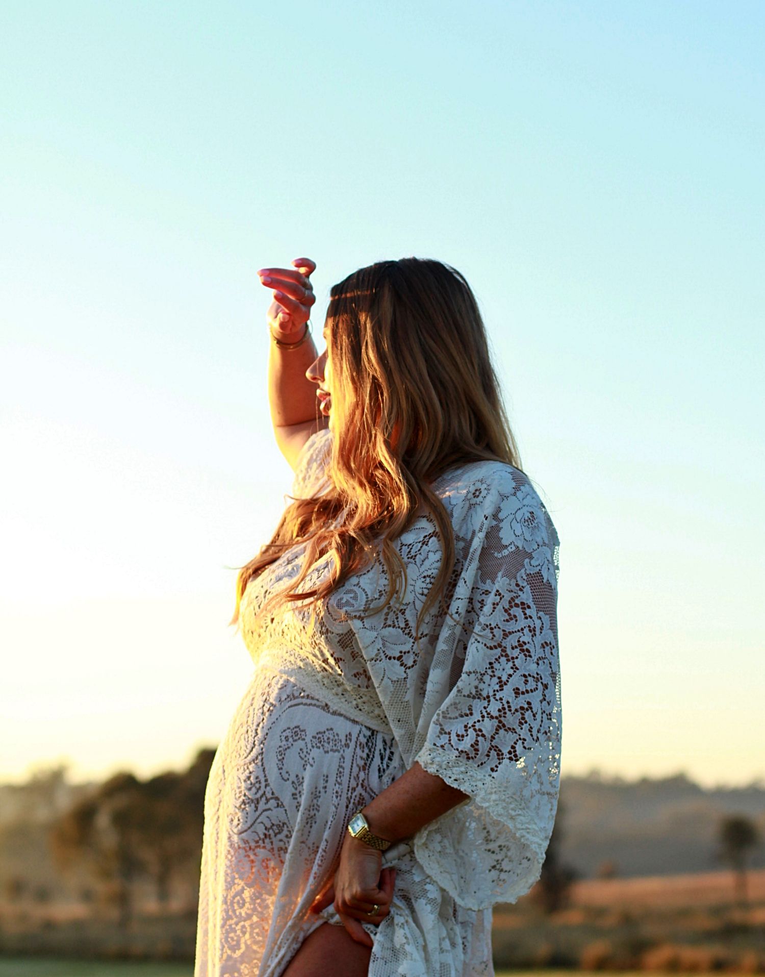 Sunrise maternity session capturing an expectant mother in soft morning light.