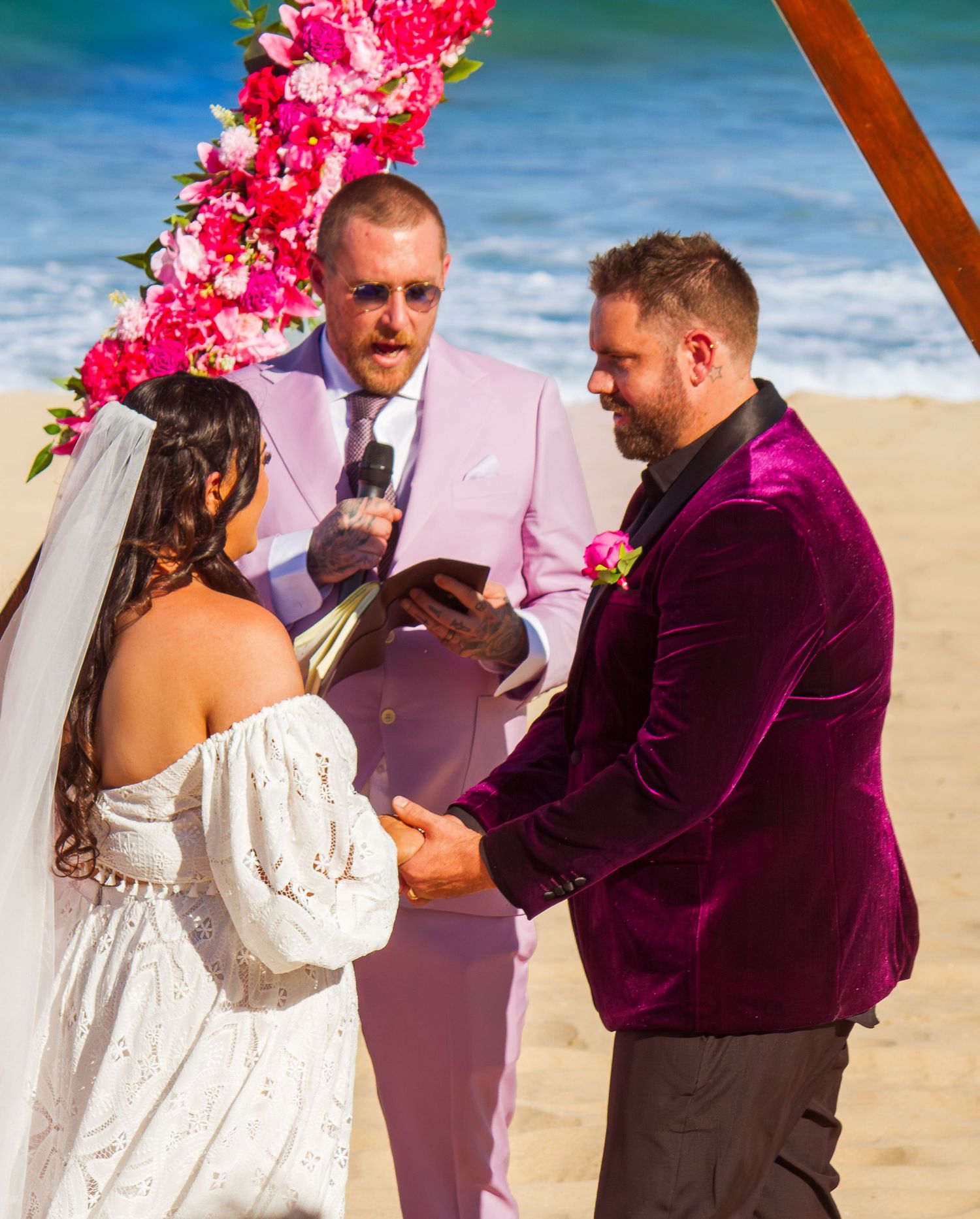 Close up of bride and groom during the ceremony exchanging emotional looks at their beach wedding.