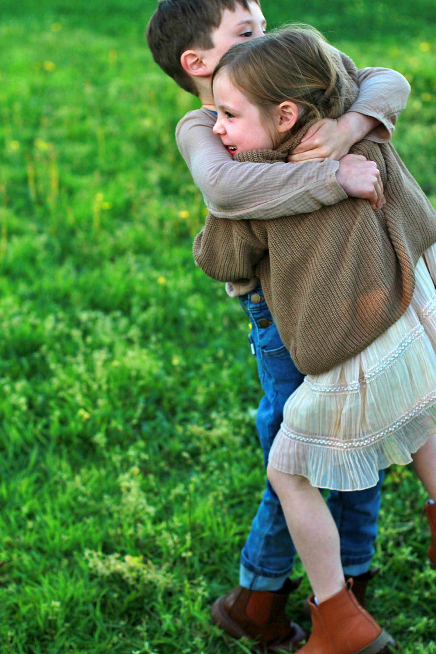 Brother and sister hugging each other during an outdoor family session