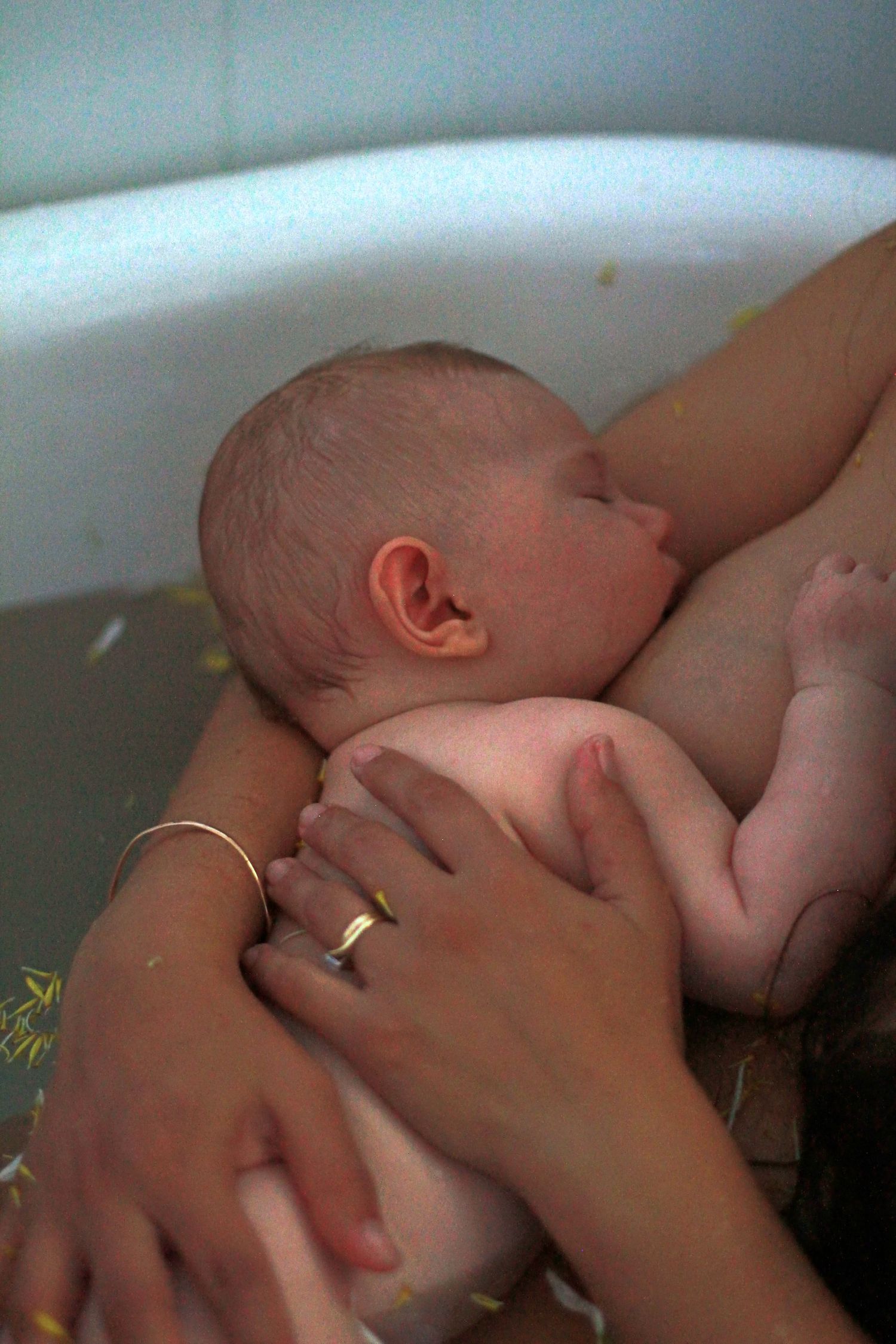 Mother breastfeeding her baby during a natural lifestyle motherhood session at home by A Lasting Impression Photography.