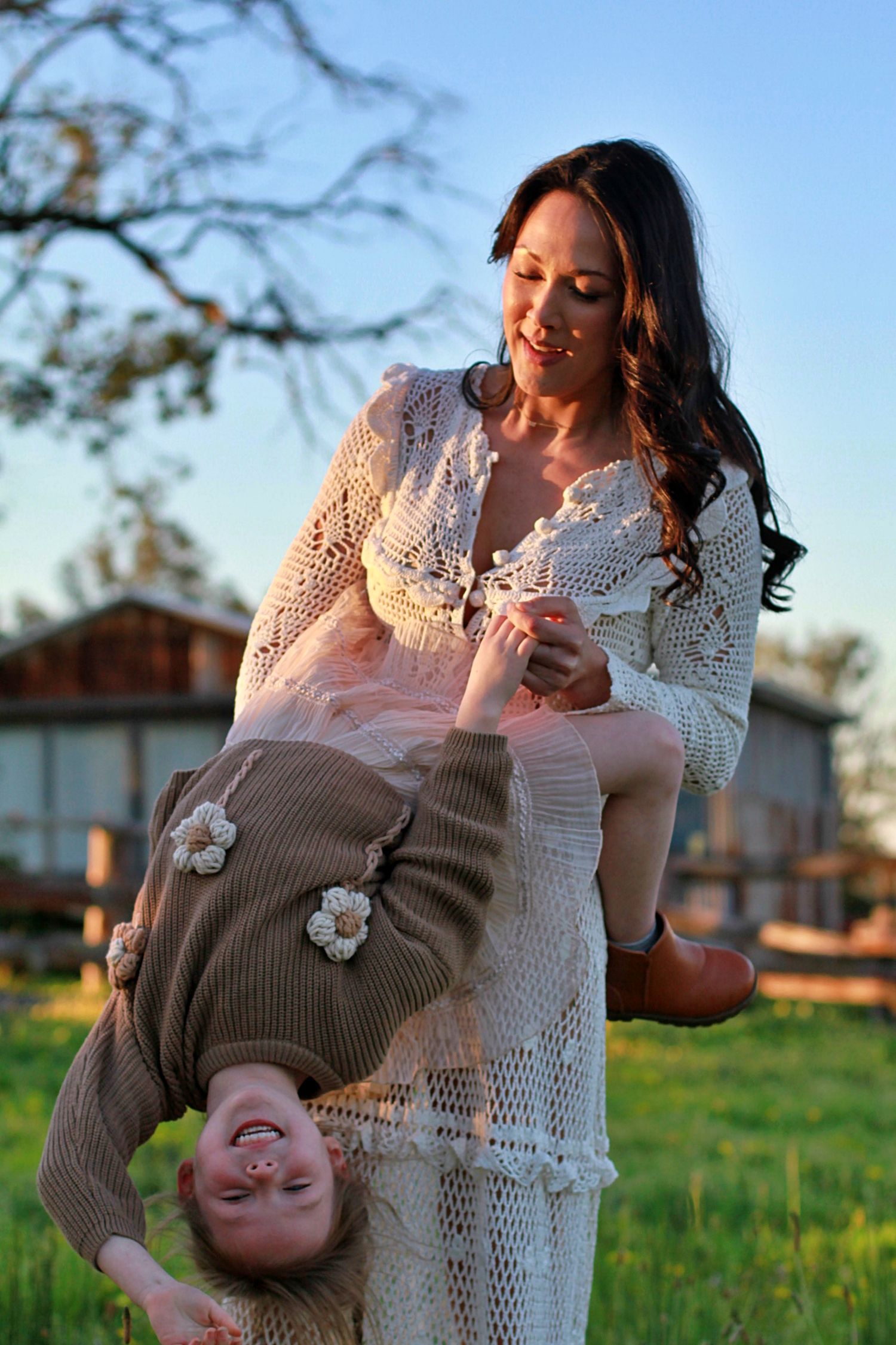 Daughter and mum playing a game in the field during a family session