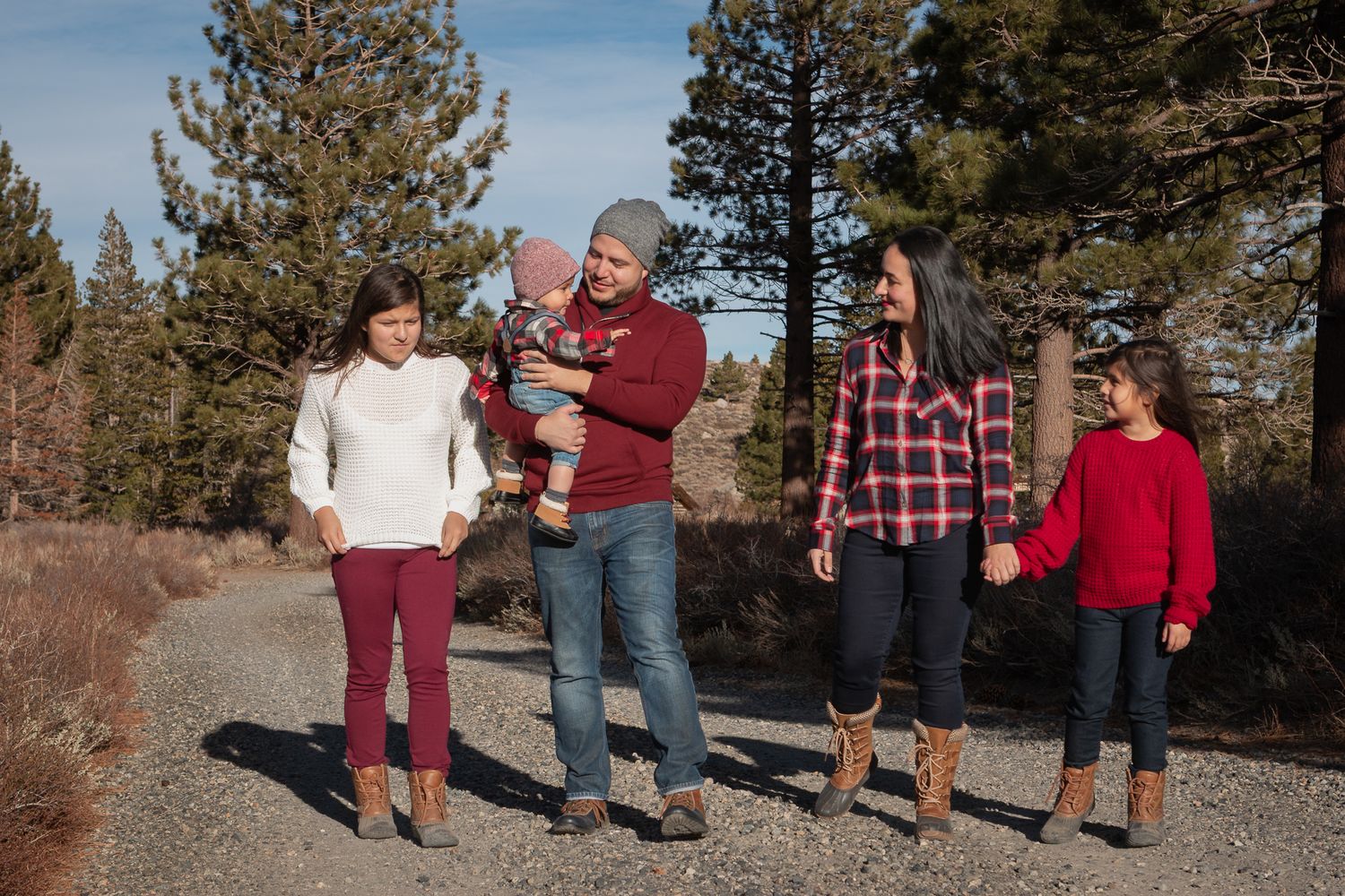 A group enjoys a casual outdoor gathering against a backdrop of mountain scenery.