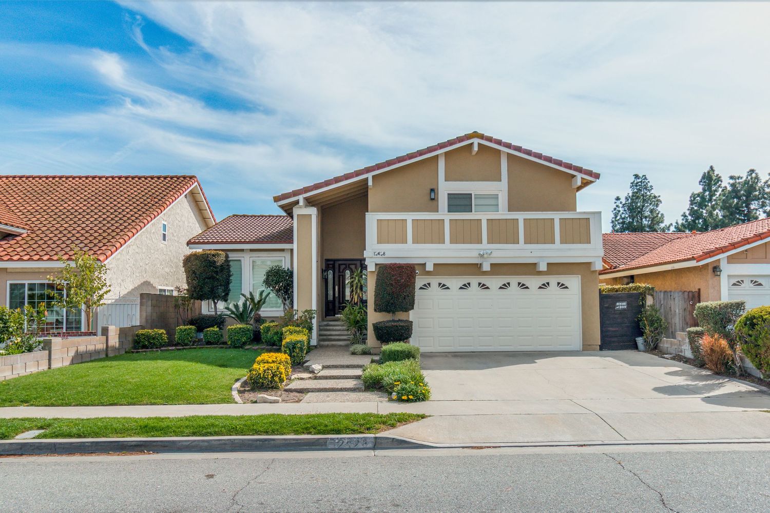 Exterior views of suburban ranch-style homes with attached garages and landscaped front yards.
