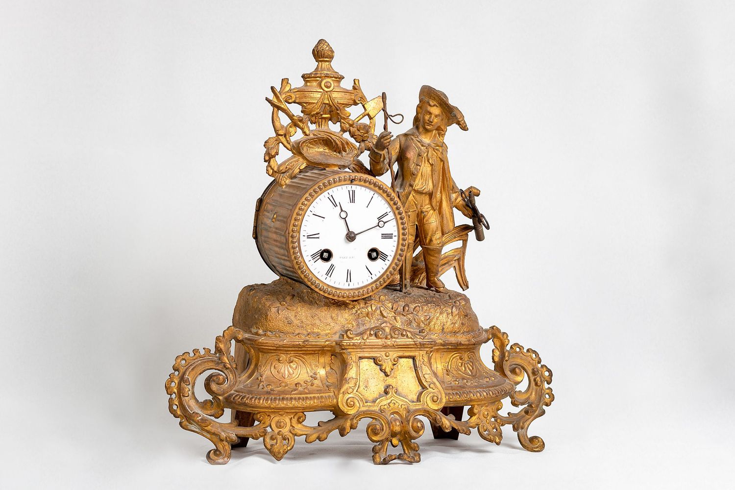 Ornate antique gold mantel clock with decorative cherub figures and intricate detailing.
