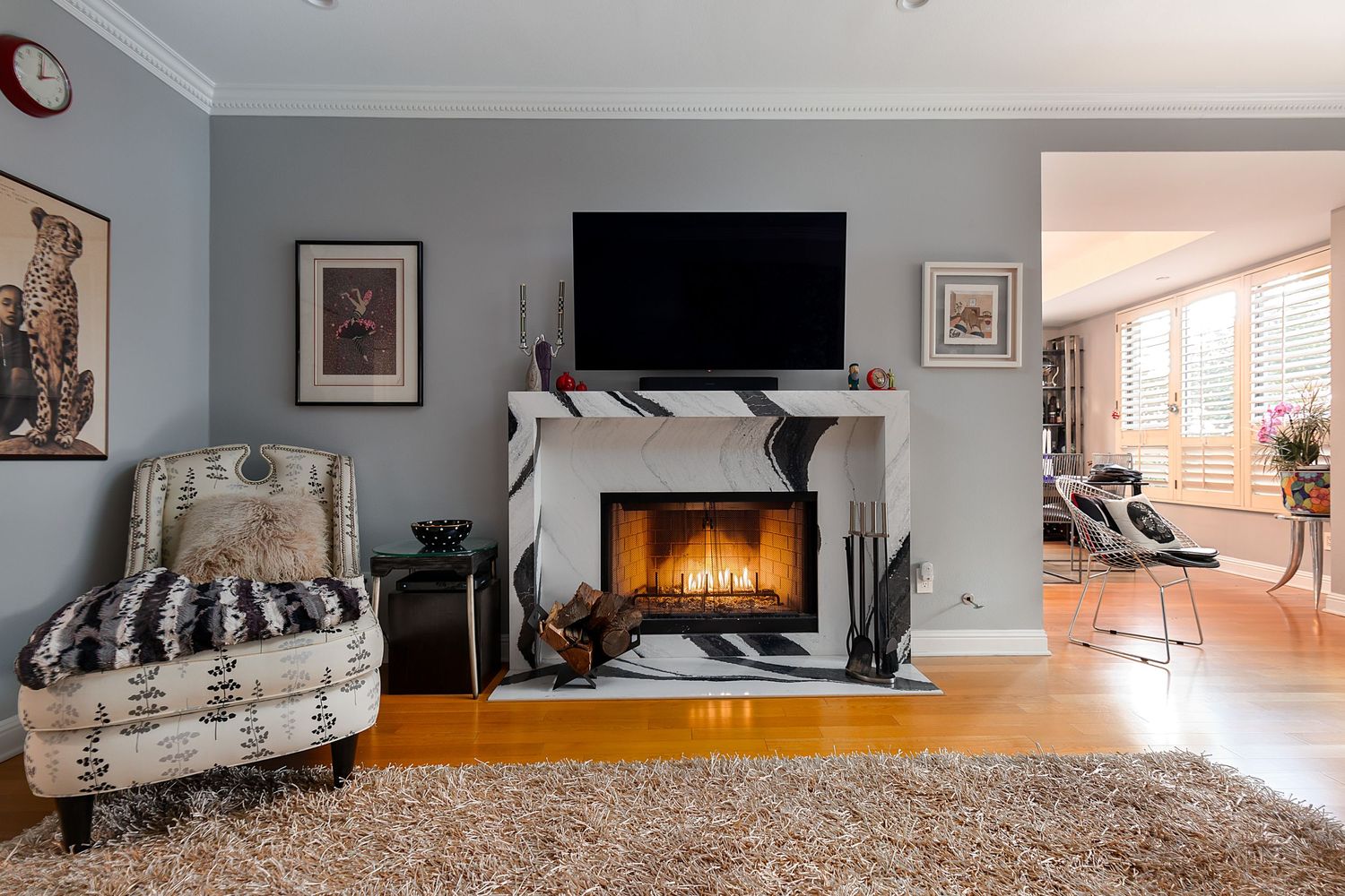 Open concept living space with fireplace, plush carpet, and modern entertainment setup.