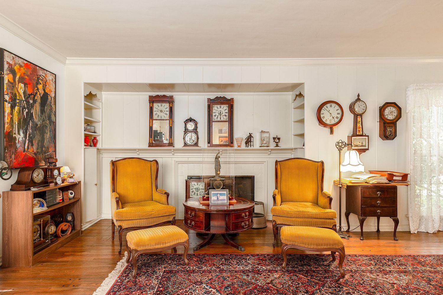 Traditional living room interior with multiple antique clocks and wooden furniture.