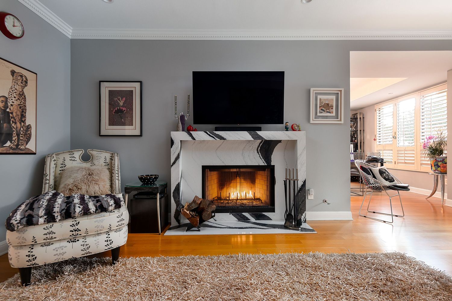 Open concept living space with fireplace, plush carpet, and modern furnishings.