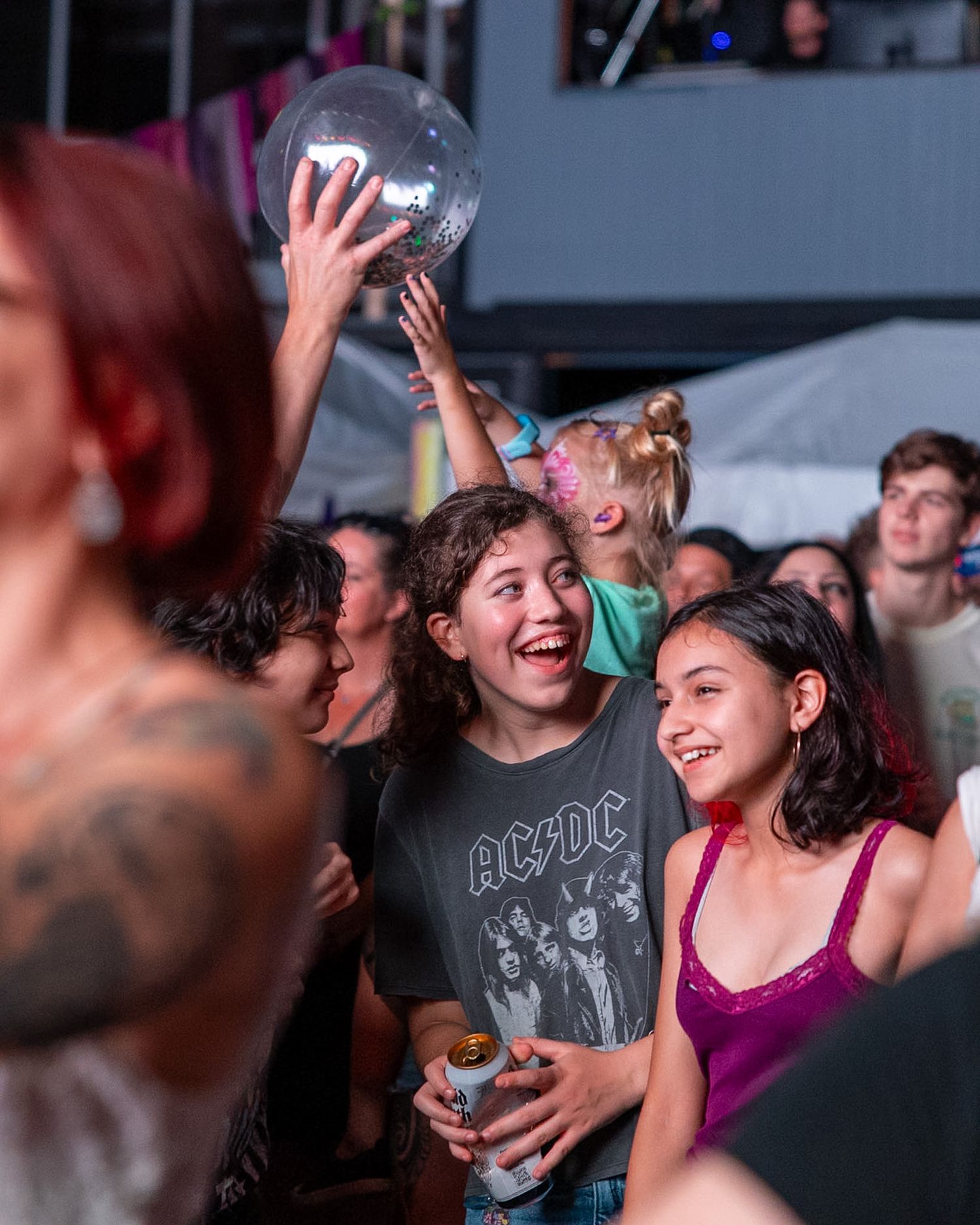 Candid event photograph of smiling children enjoying a moment together.