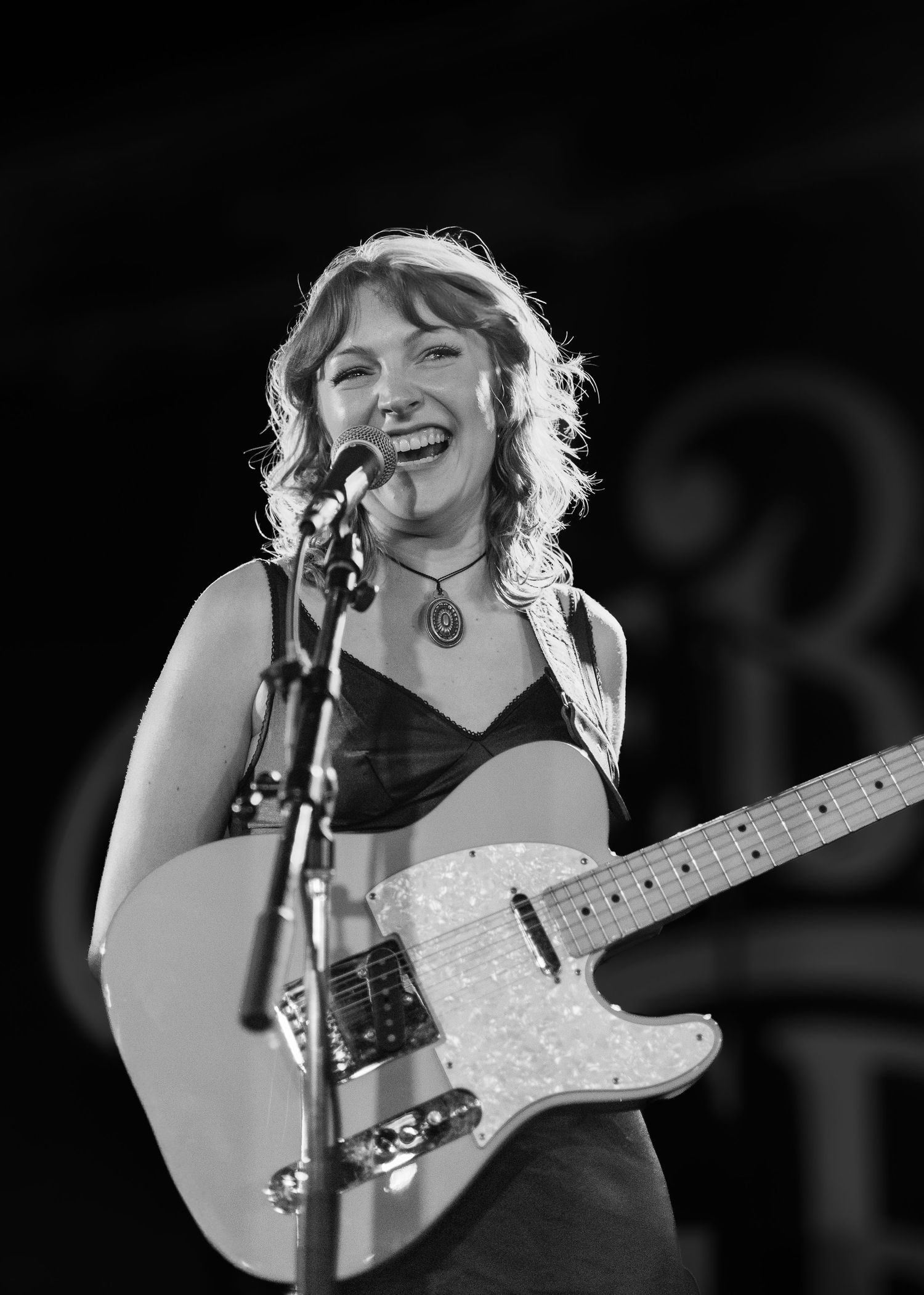 Black-and-white portrait photograph of musician Emily How at Carol’s Pub in Chicago, Illinois.