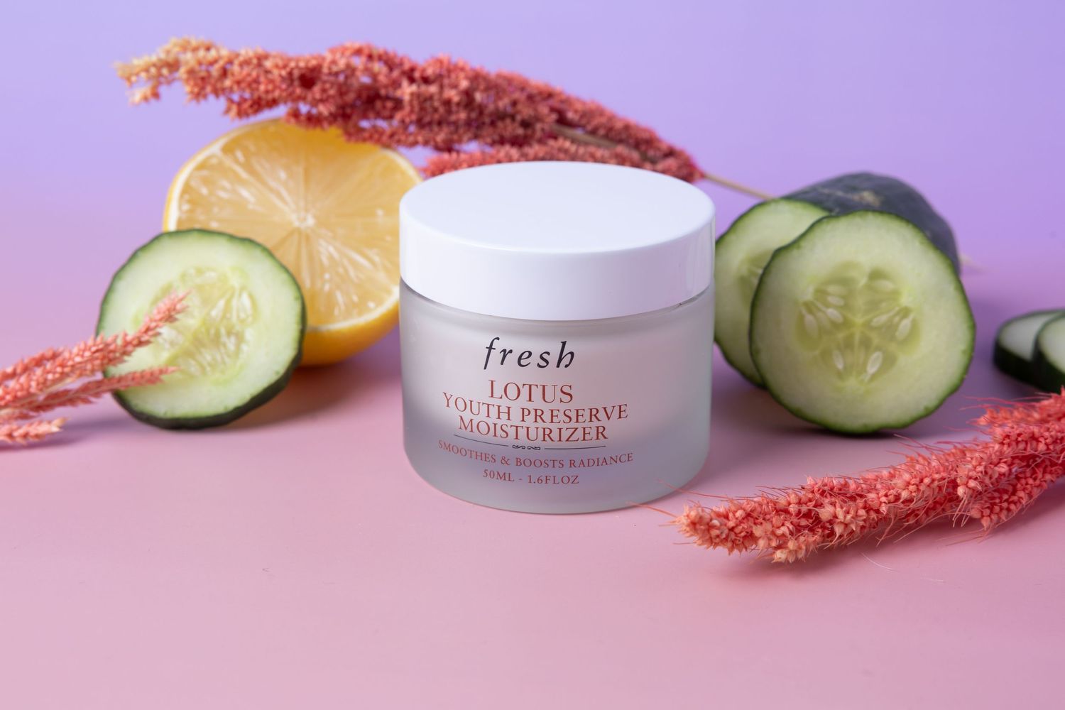 Skincare product photograph of Fresh Lotus Youth Preserve moisturizer styled with natural ingredients.