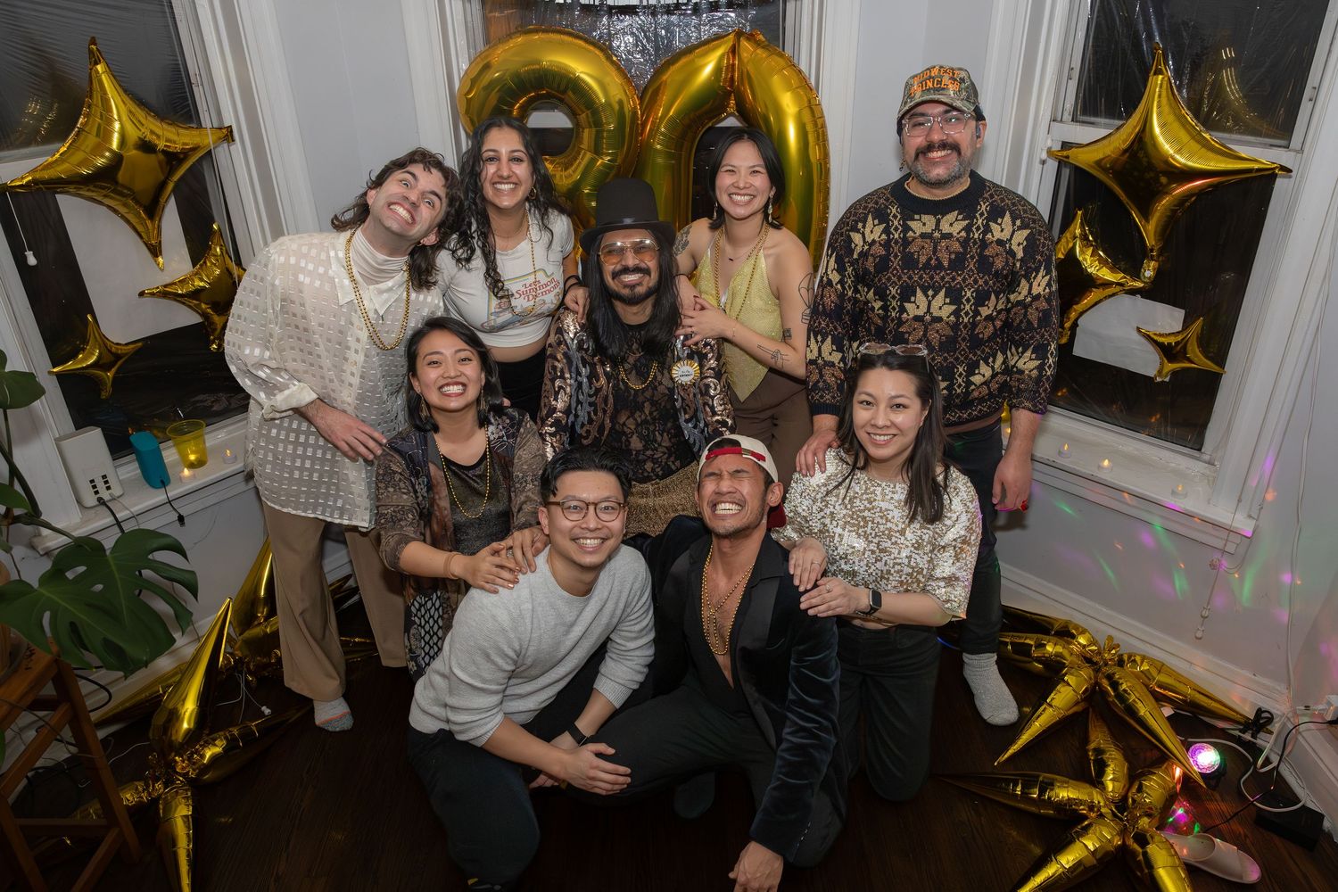 Candid event photograph of smiling guests enjoying a birthday party celebration.