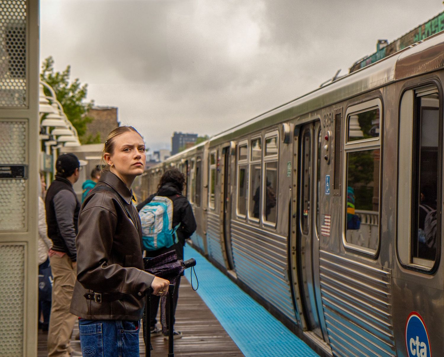 Lifestyle portrait of a woman waiting for a train at a Chicago transit station.