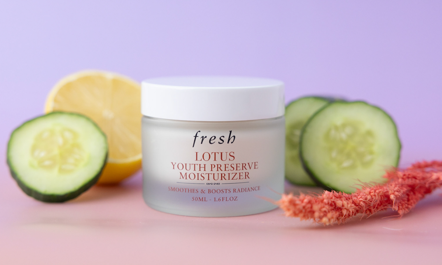 Product photograph of Fresh Youth Preserve moisturizer surrounded by fresh fruit and botanicals.
