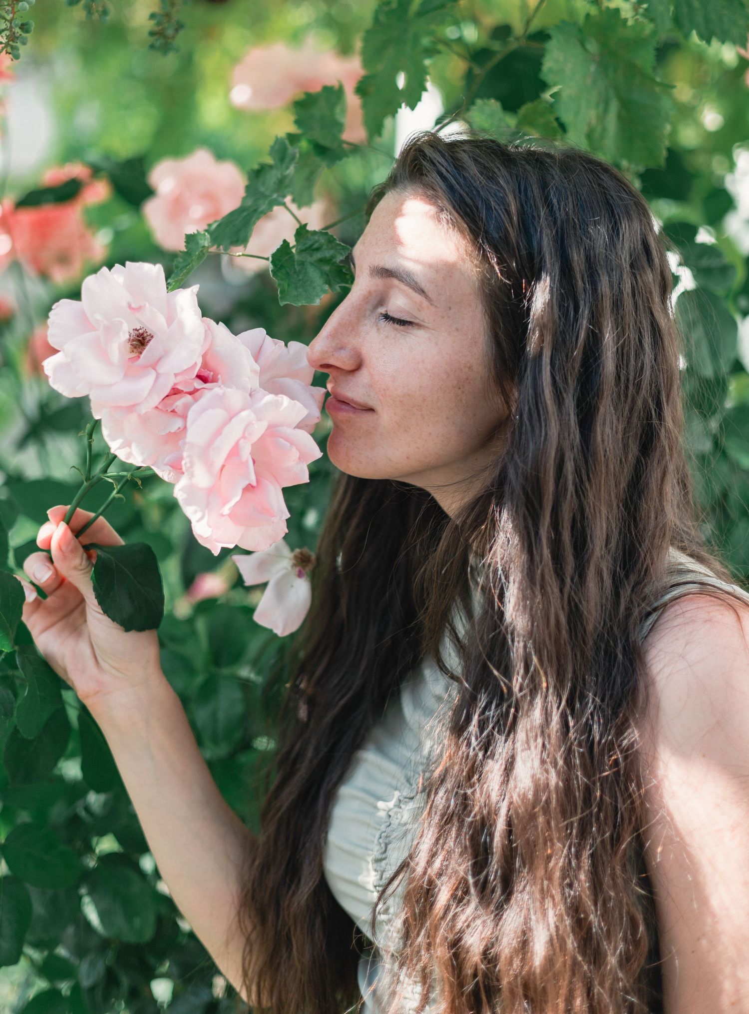 Beautiful girl with beautiful roses around her