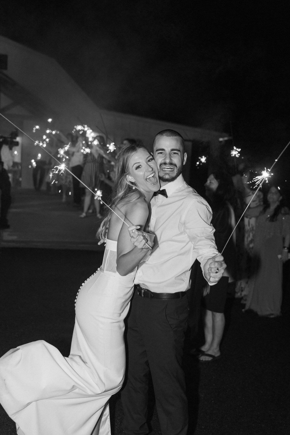 A elopement celebration moment captured in black and white with sparklers glowing as a bride and groom dance the night away in Denver CO