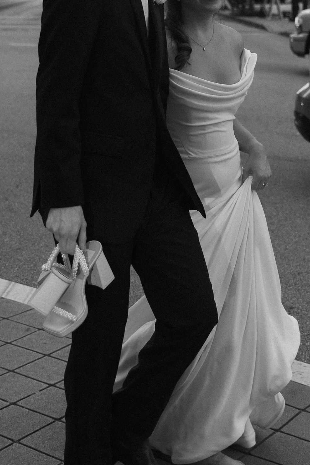 Black and white photo of a newlywed couple walking through the street in Atlanta, GA on their courthouse elopement day.
