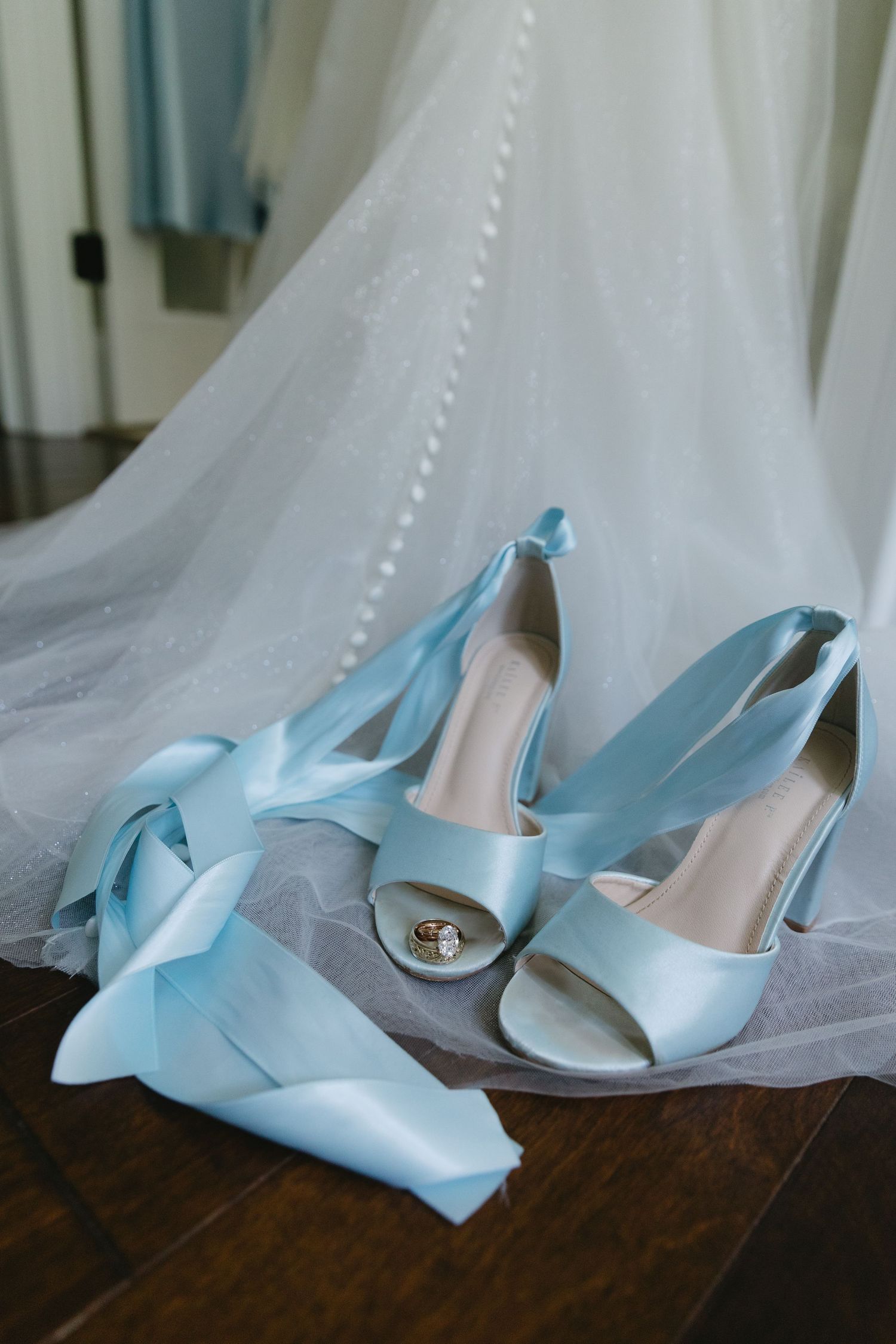 Light blue satin wedding shoes and matching ribbon on white tulle veil background for a beautiful Telluride, Colorado elopement day.