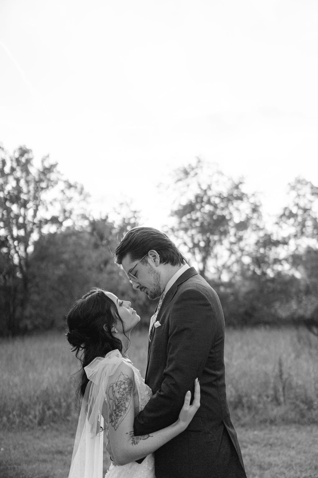 Couple golden hour embrace at Blue Heron Barn Michigan Wedding
