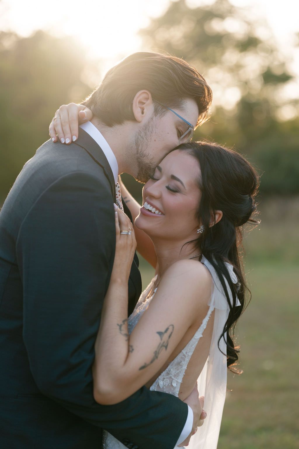 Couple embracing at sunset at Blue Heron Barn photographed by Michigan photographer Kayla Raquel Photo.