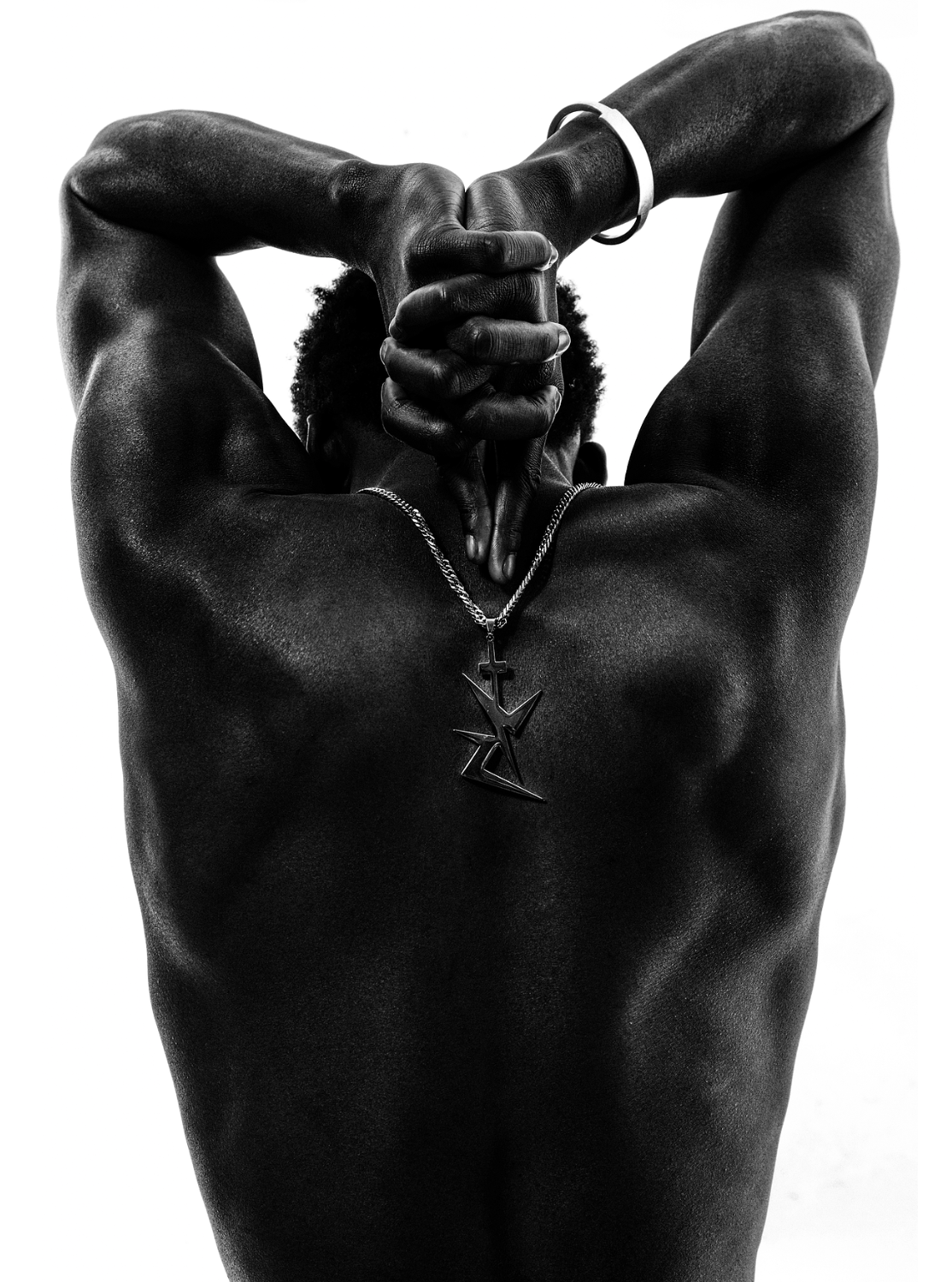 Dynamic, strong pose, black and white picture of boy's back