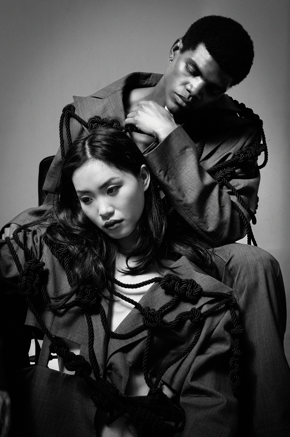 Boy and girl sitting intimately wearing matching suits