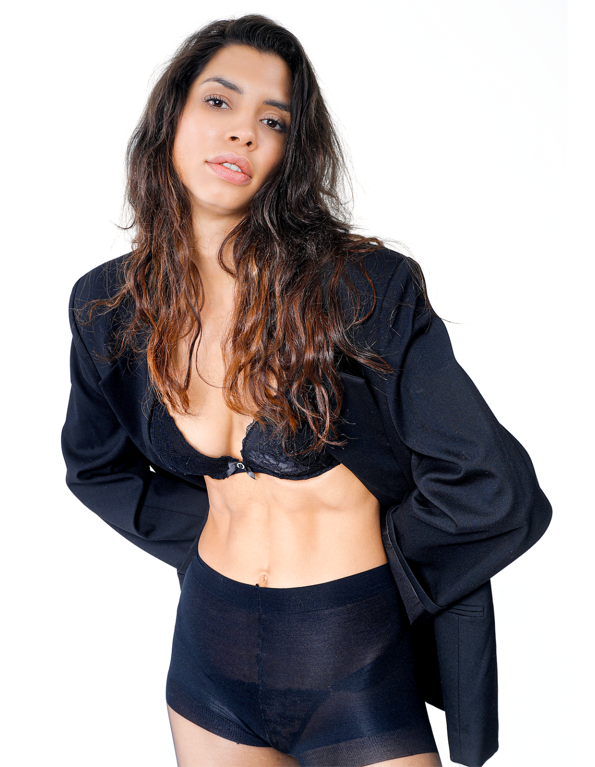 Girl in a blazer and tights, striking a pose