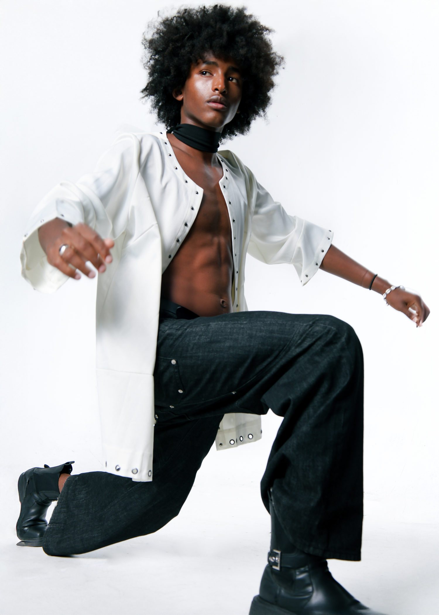 Boy lunging with white open button down shirt and black jeans