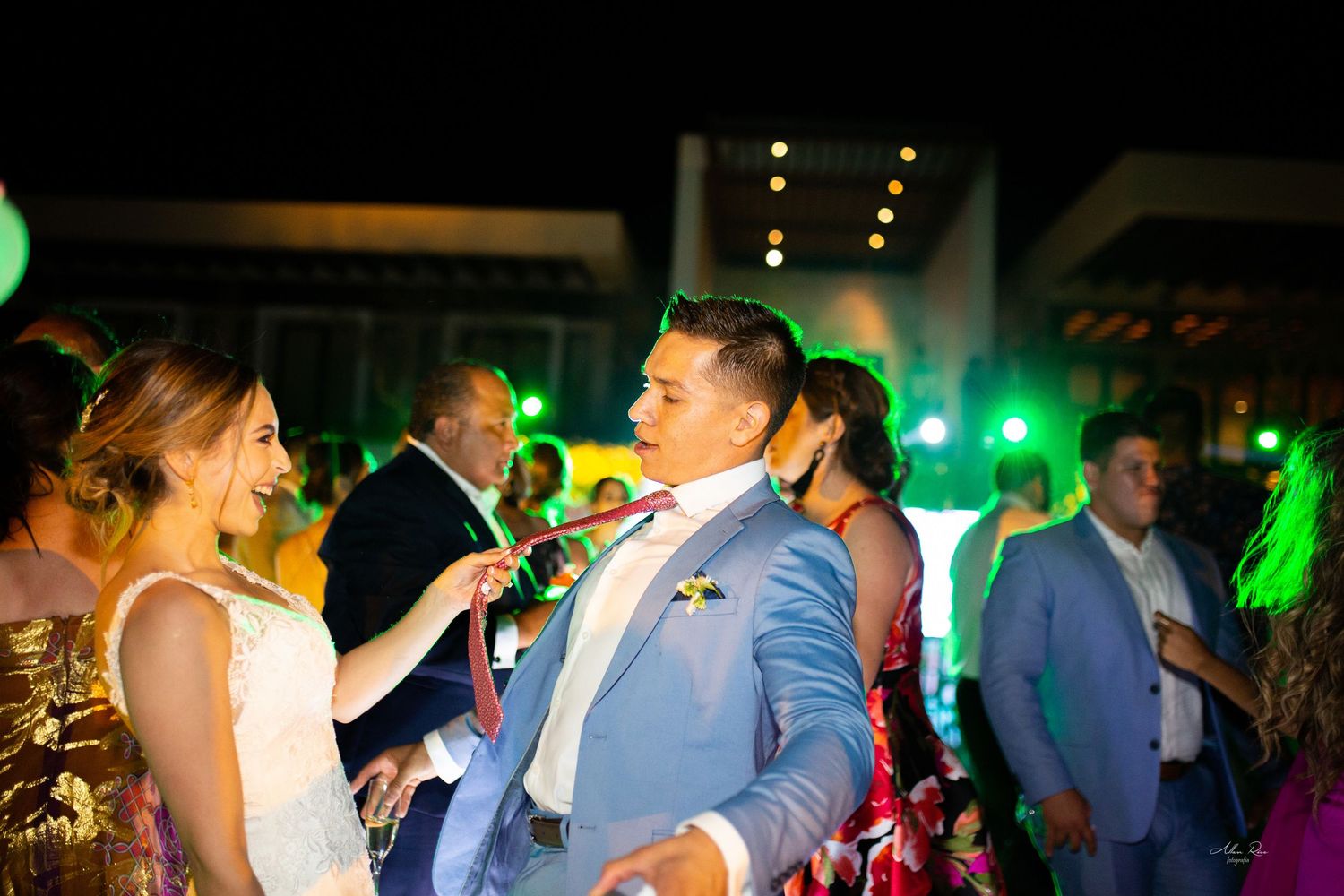 Bride and groom sharing dance together at elegant outdoor evening wedding reception.