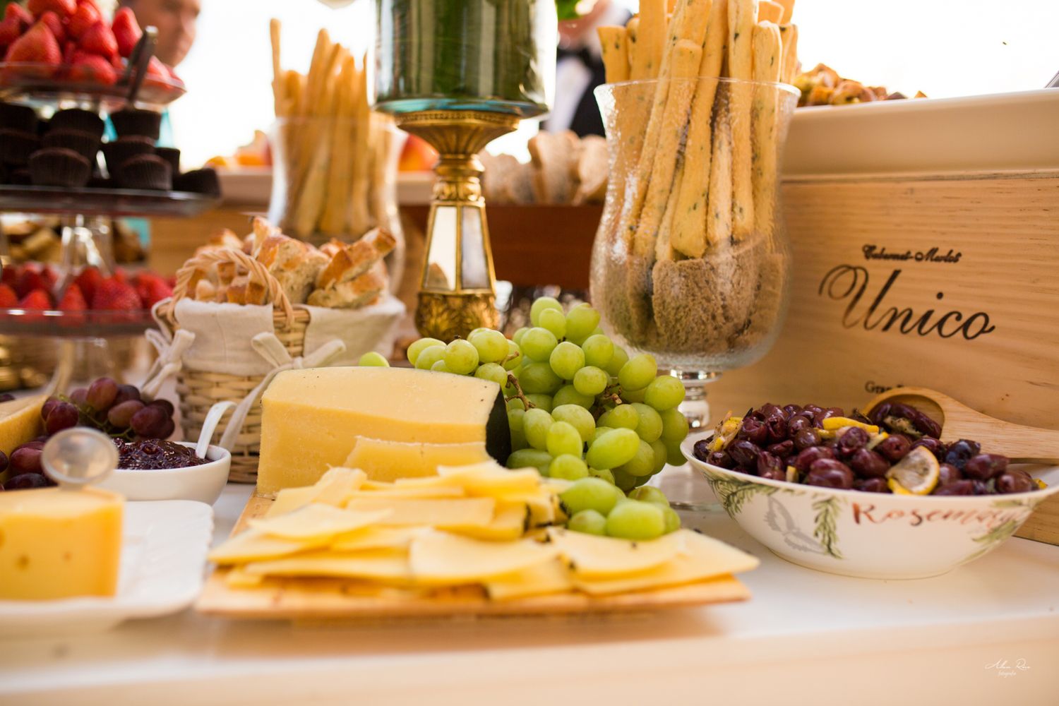 Elegant wedding charcuterie display featuring cheeses, grapes, breadsticks, and assorted accompaniments.