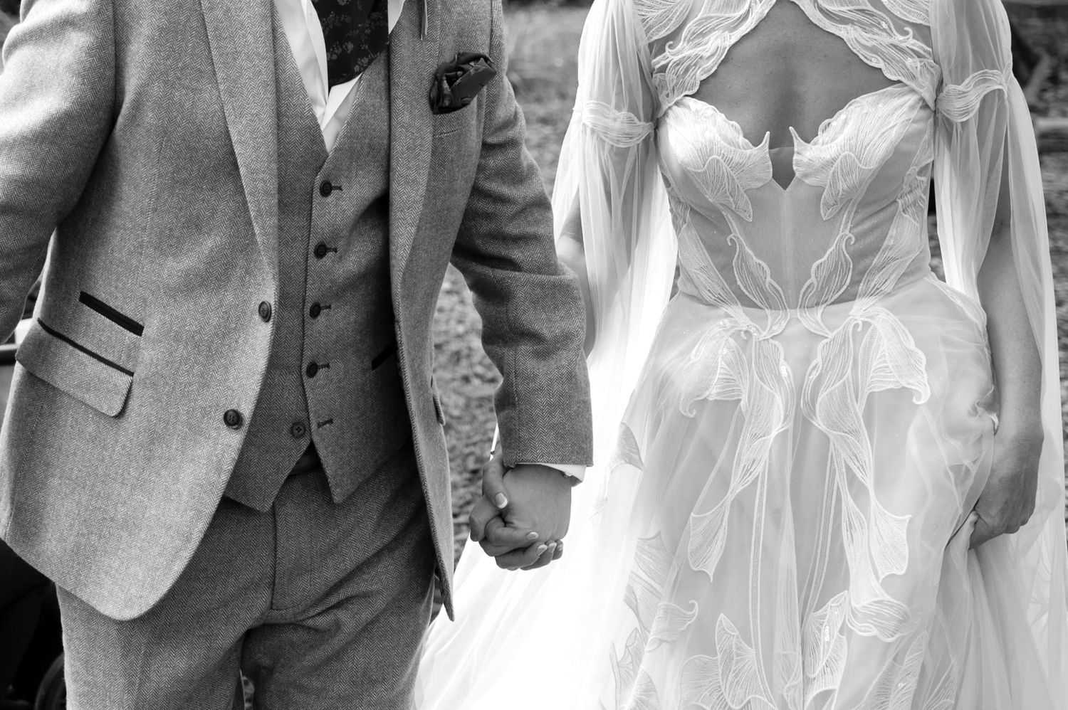 Tweed three piece suit with pocket square and corseted tulle dress with long sheer floating sleeves.